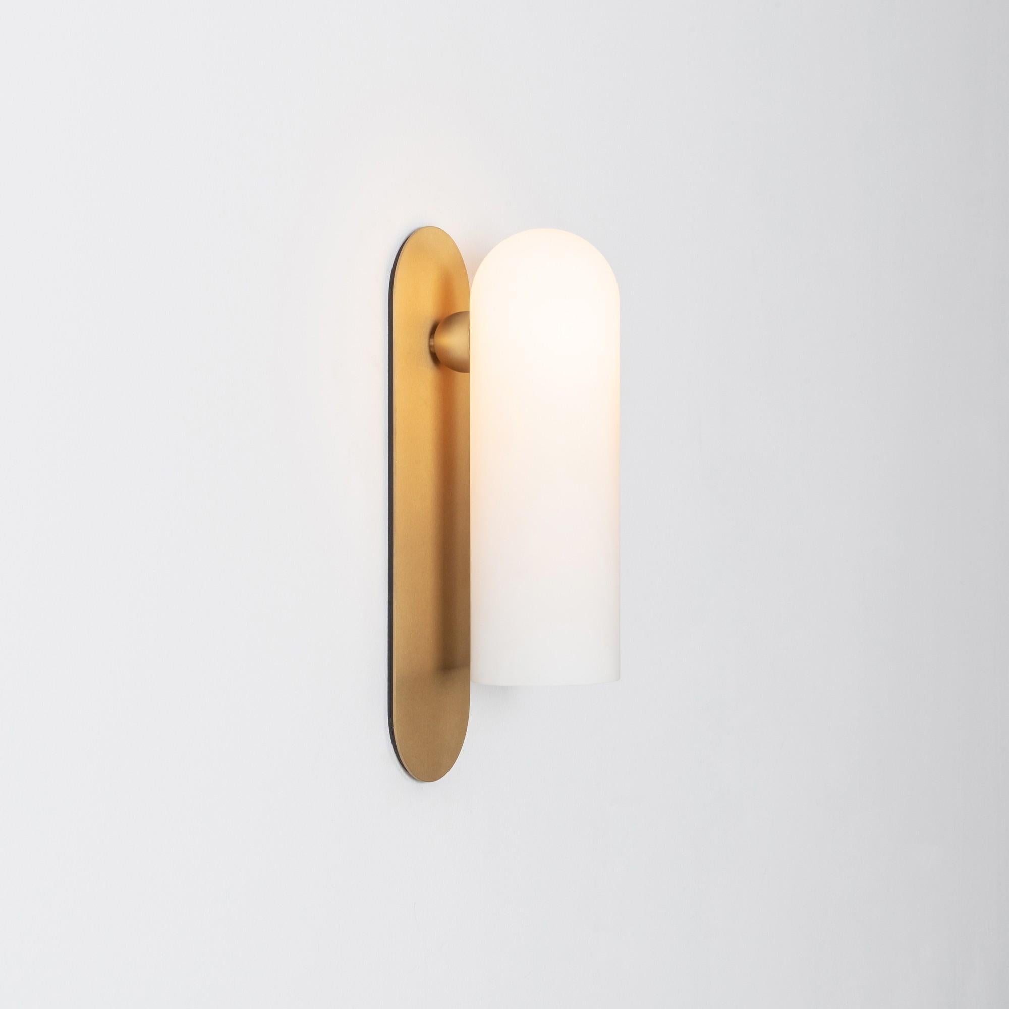 Brass large sconce by Schwung
Dimensions: W 10.5 x D 14 x H 38 cm
Materials: Brass, frosted glass

Finishes available: Black gunmetal, polished nickel, brass

Schwung is a German word, and loosely defined, means energy or momentumm of a positive