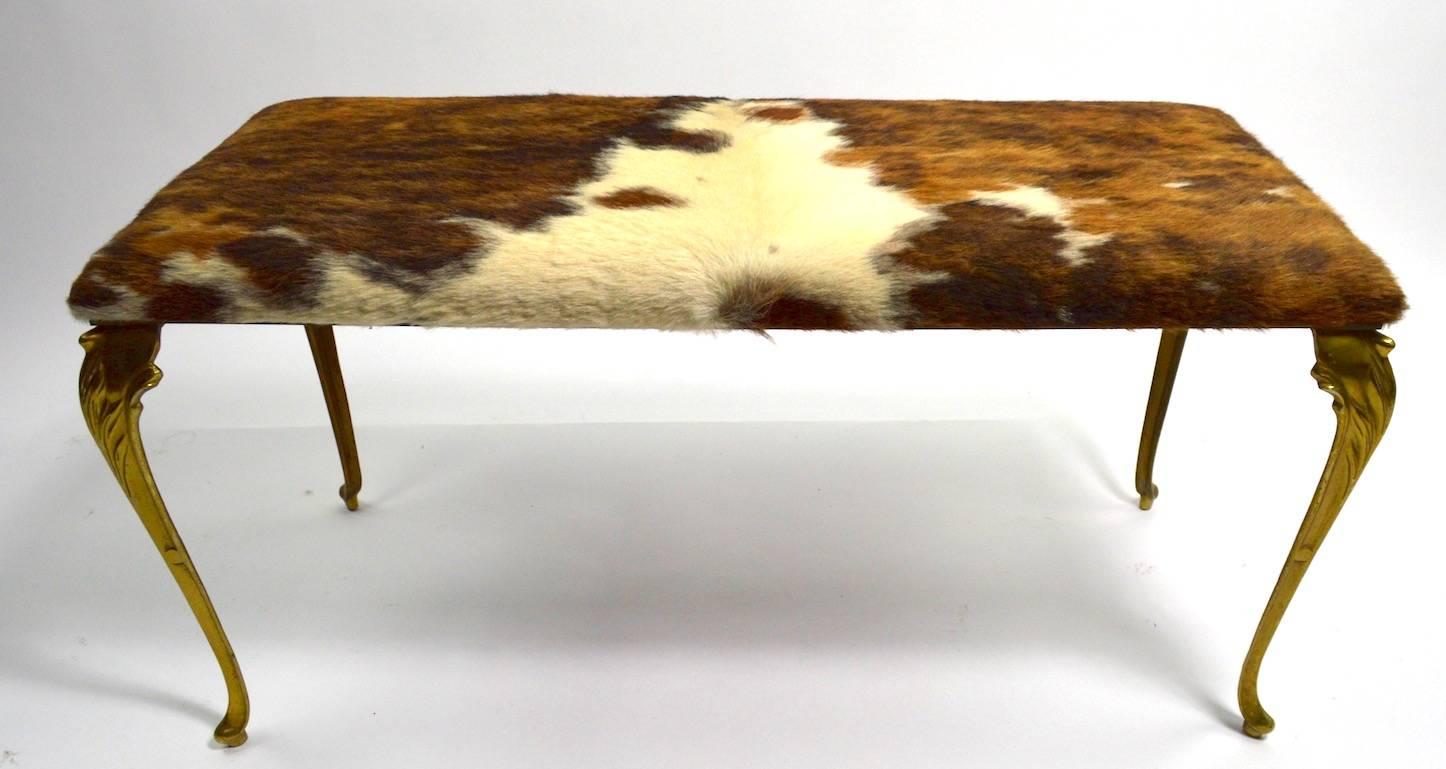 Stylish bench with cast brass cabriole legs and pony fur upholstered seat (upholstery done by Debra Miller NYC ).
Very well designed and constructed, great size functions as a window bench, pouf, or stool.