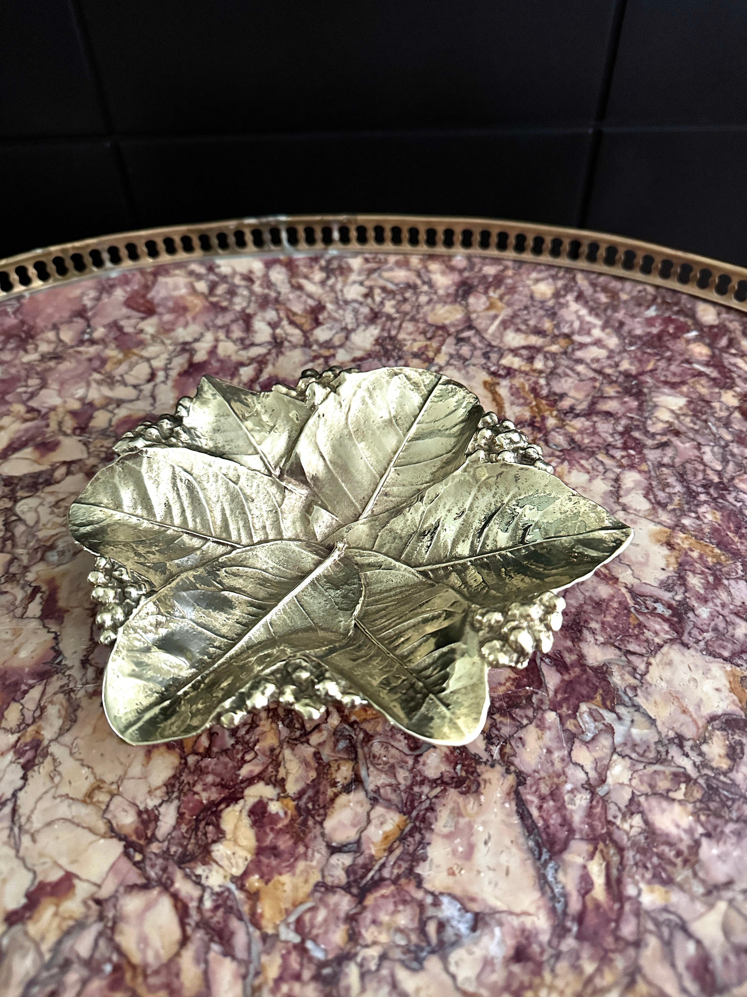
A rarely seen vintage heavy solid brass Lemon Leaves bowl, made in Waynesboro, Virginia by Virginia MetalCrafters. The leaf was designed by Oskar Hansen, it is hand crafted, hand finished and of the highest quality, probably made in the 1960's. The