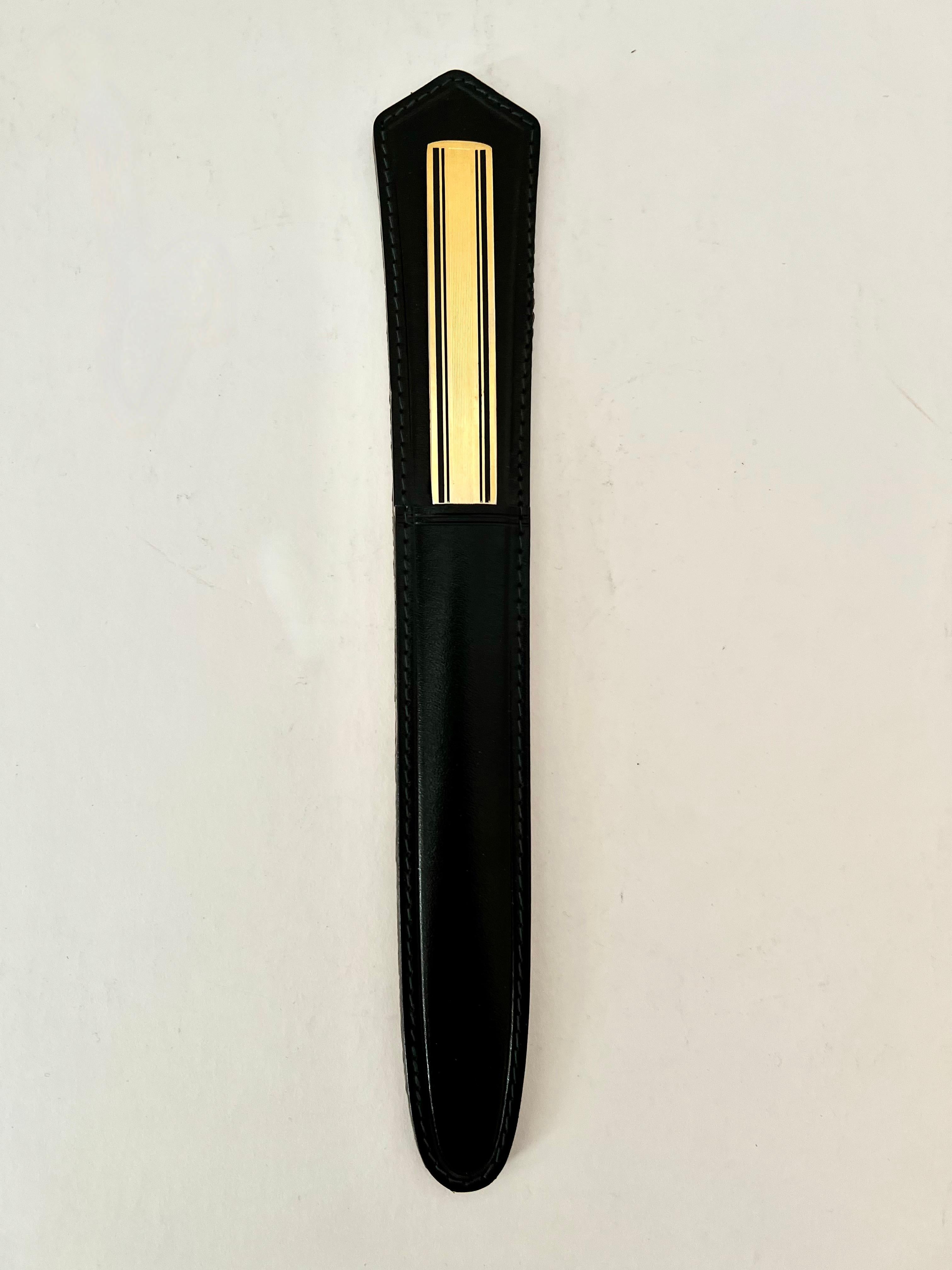Solid Brass Letter opener with leather case. The brass letter opener has a matte finish with black line details and fits nicely in its case when not in use. 

Made in Germany, the pair are a compliment to any desk or work station and are