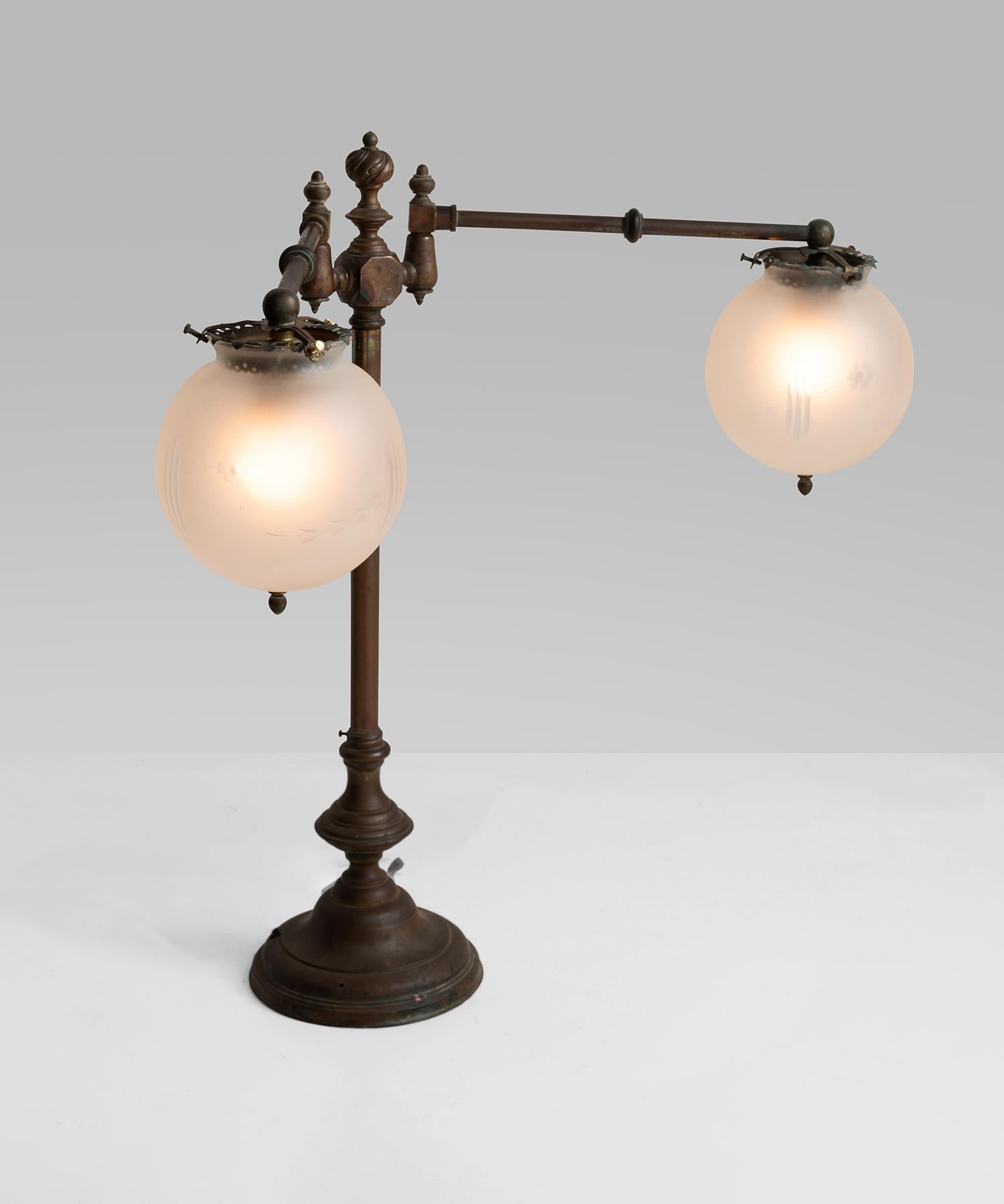 Unique articulating desk lamp with ornate finials and frosted glass shades with etched floral motif.
