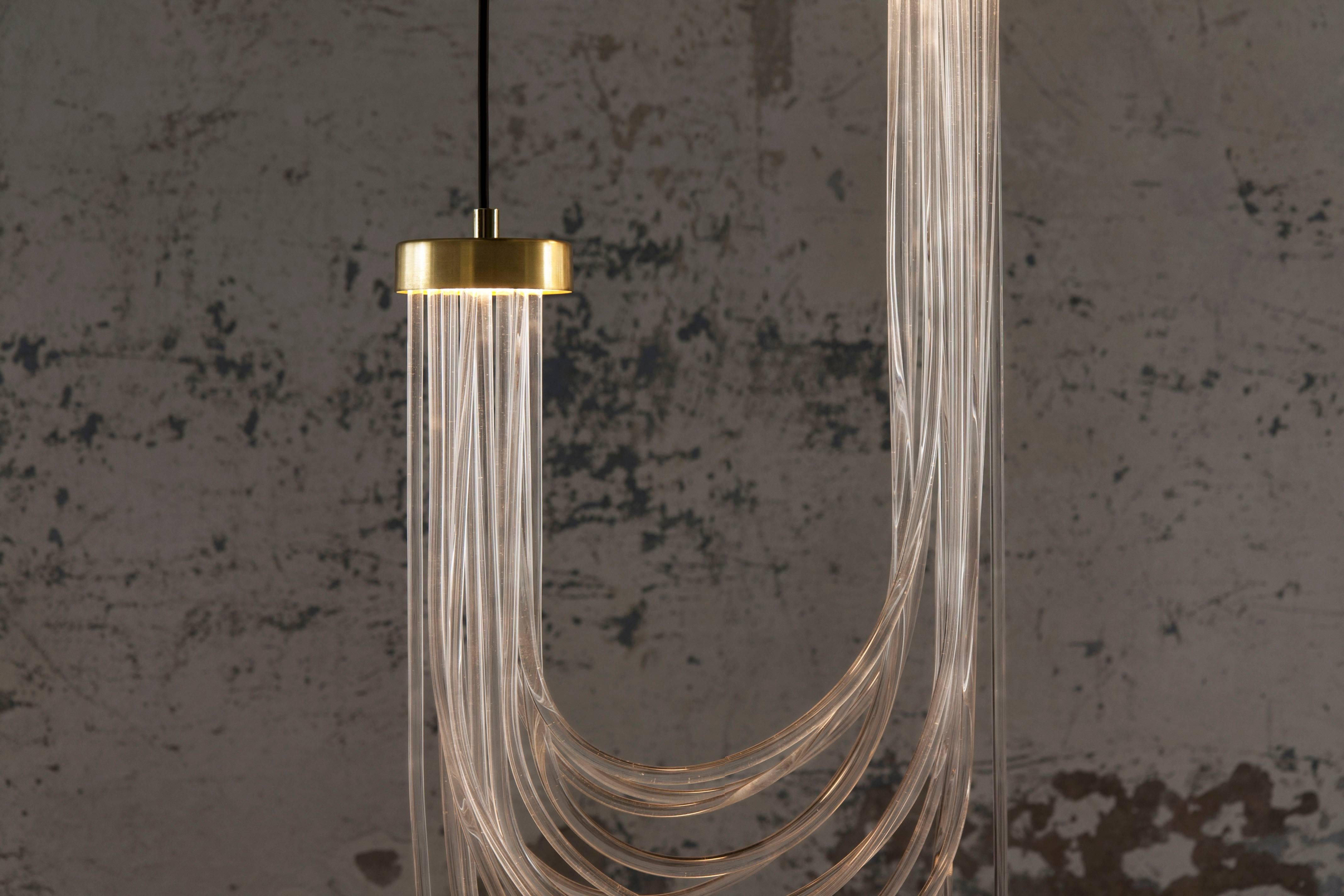 Double Cascade
Pendant lamp
Materials: polished brass, pmma, LED light
Dimensions: 90 x 40 x 10 cm (variable)
light source: 2xLED boards 500 mA - 12,4 w (max) - 3.000 k - 1.770 lm
driver: external (AC 220v/ DC 24v)

Cascade tells about the