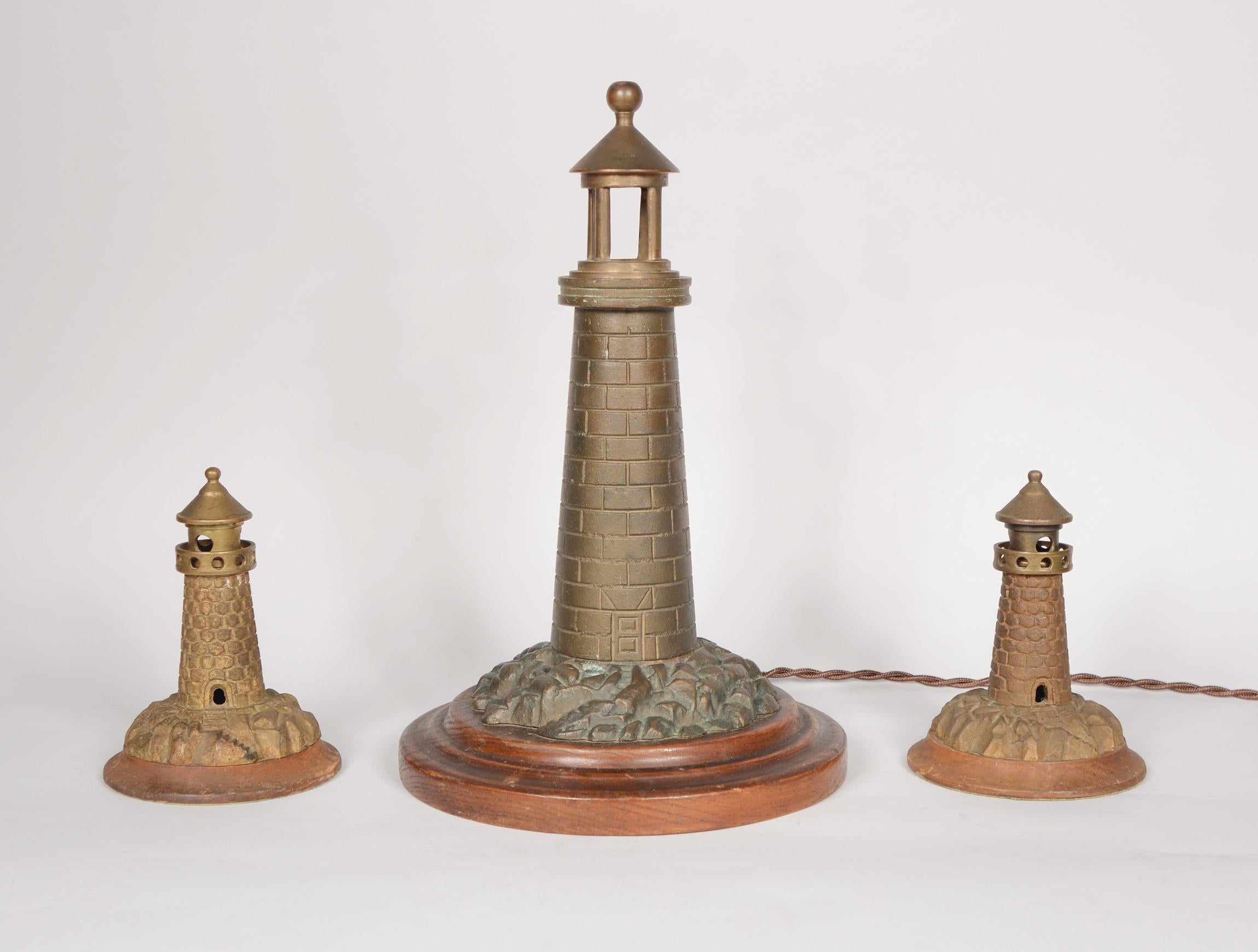 Cast brass lighthouse lamp from about 1920. This lamp came from an estate with two smaller cast brass lighthouses. We don't believe these originally came together as a set, but they have been a set for many years now. The small lighthouses do not