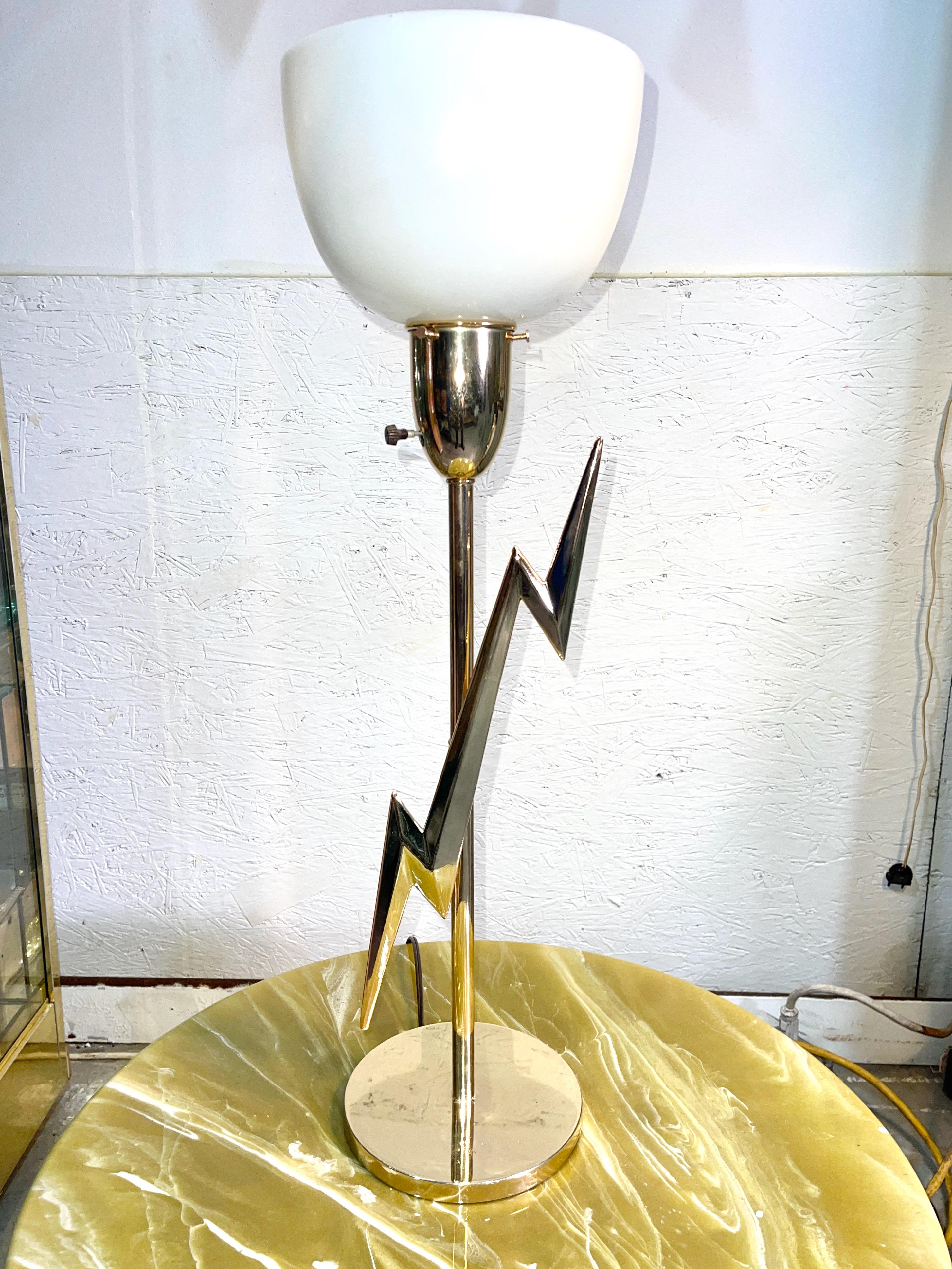 Unicorn. I've never seen another. Rare mid-century modern table lamp fitted on the stem with a three dimensional lightning bolt. 
Designed by Edmund (Edmond) Spence for Rembrandt Lamps Corp.
The brass has been newly replated.
Uplight fitted with a