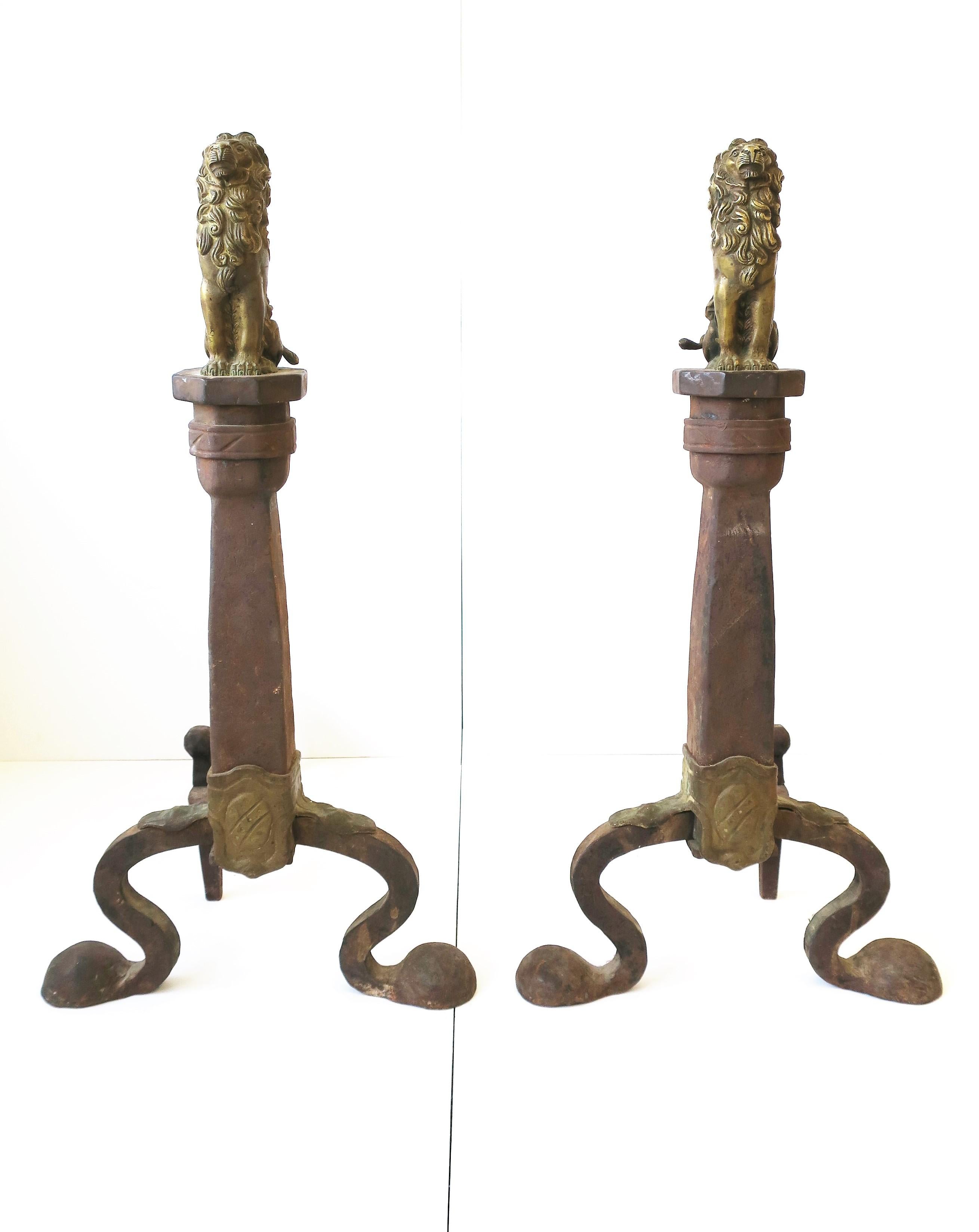 A regal and substantial pair iron and brass lion andirons, circa late-19th century. Iron and brass andirons have relatively large and detailed brass lion sculpture; Lion sits atop octagonal iron base, with great attention to detail shown in paws,