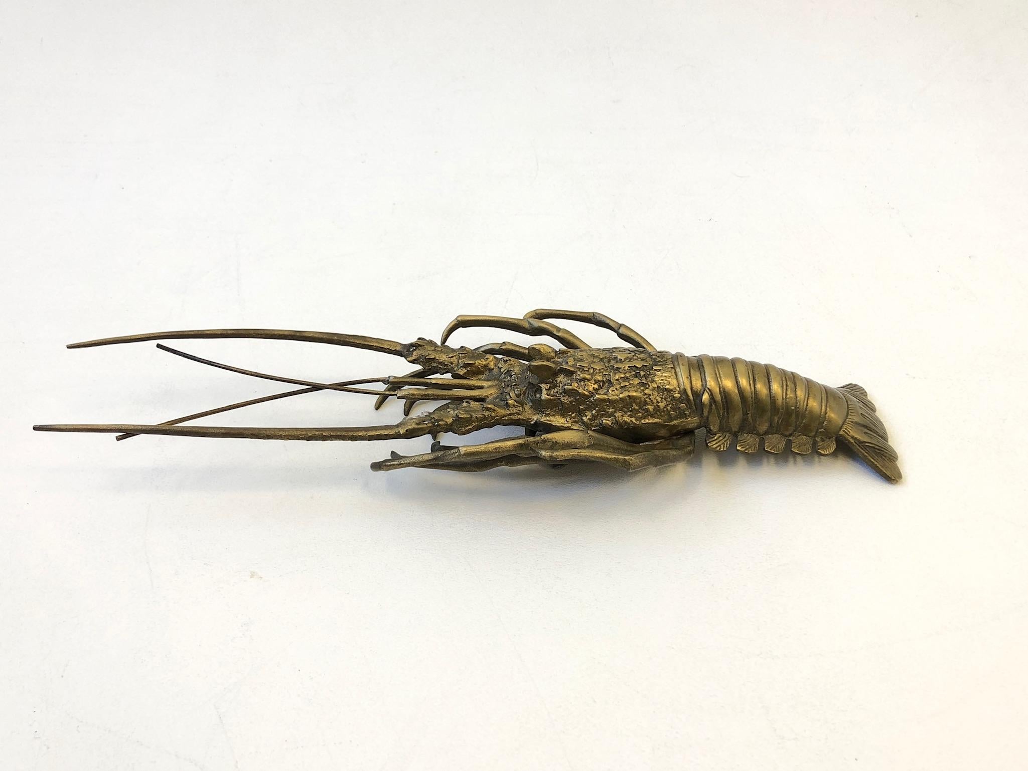 A cool 1970s solid brass lobster sculpture. 
Dimensions: 5.5” deep 16” wide 2” high.