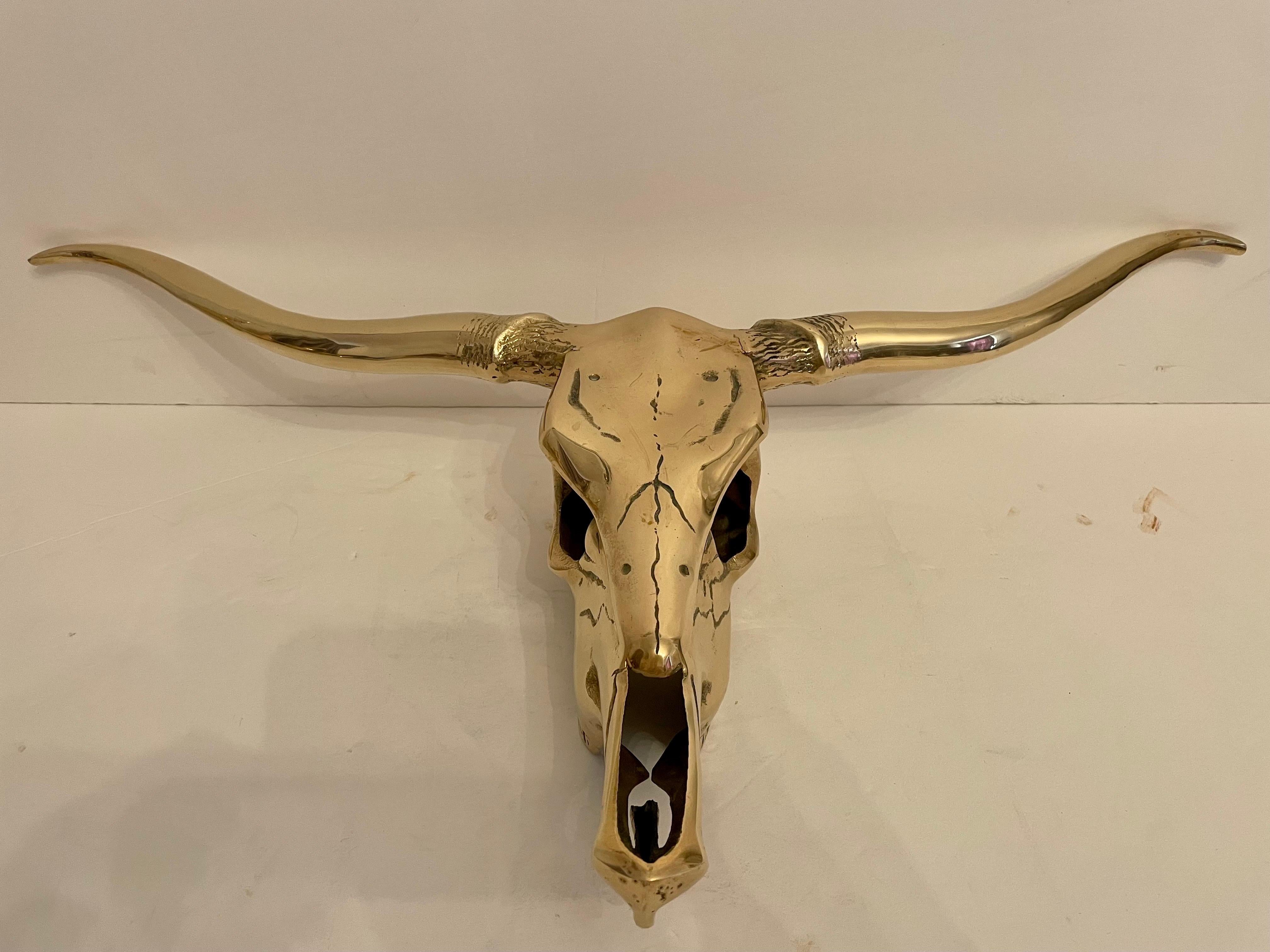 Circa mid-20th century Hollywood Regency style decorative brass longhorn skull wall sculpture in a hand polished finish. Please note of wear consistent with age. Good overall condition. Large scale