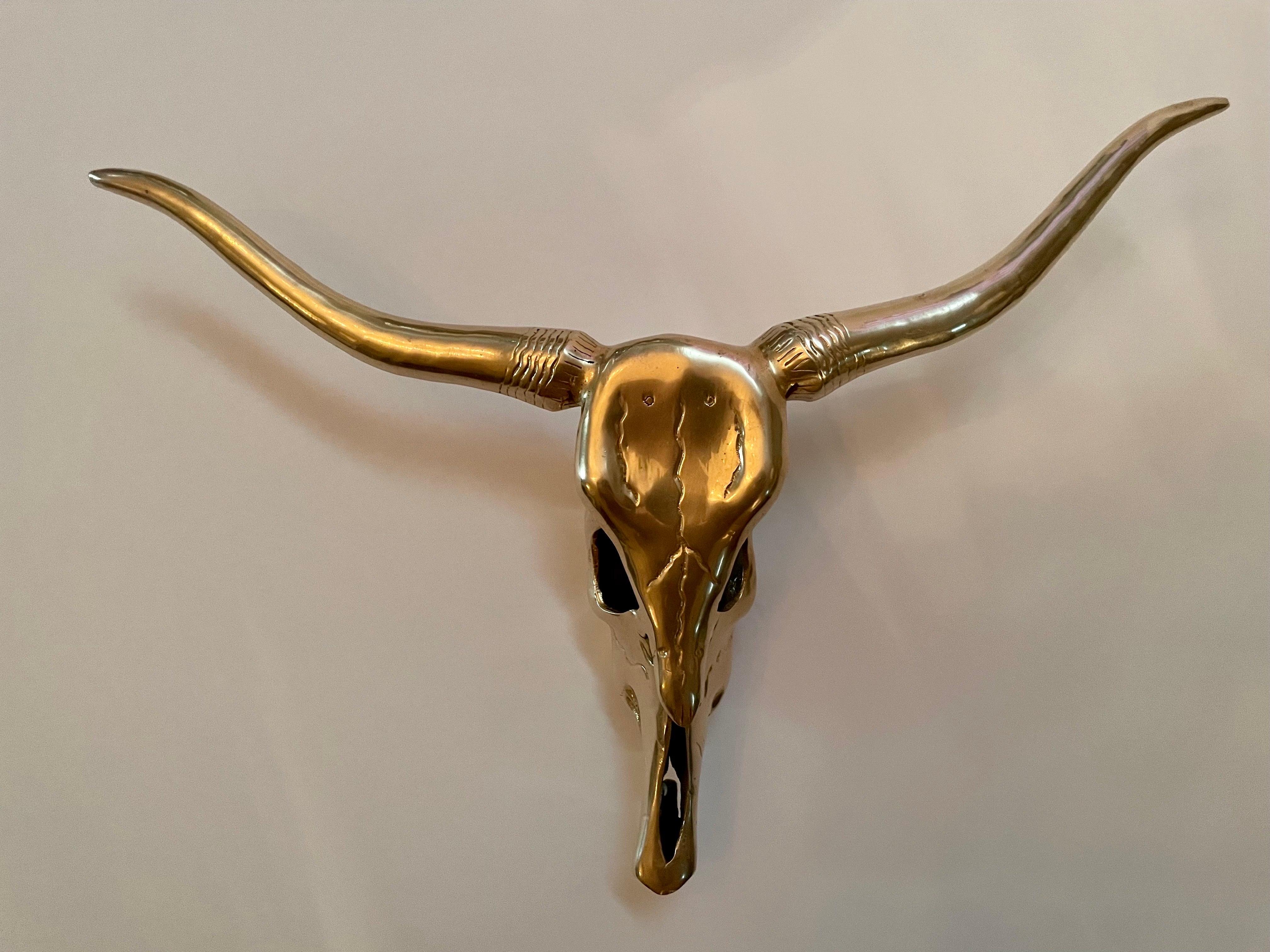 Circa mid-20th century Hollywood Regency style decorative brass longhorn skull wall sculpture in a hand polished finish. Please note of wear consistent with age. Good overall condition.