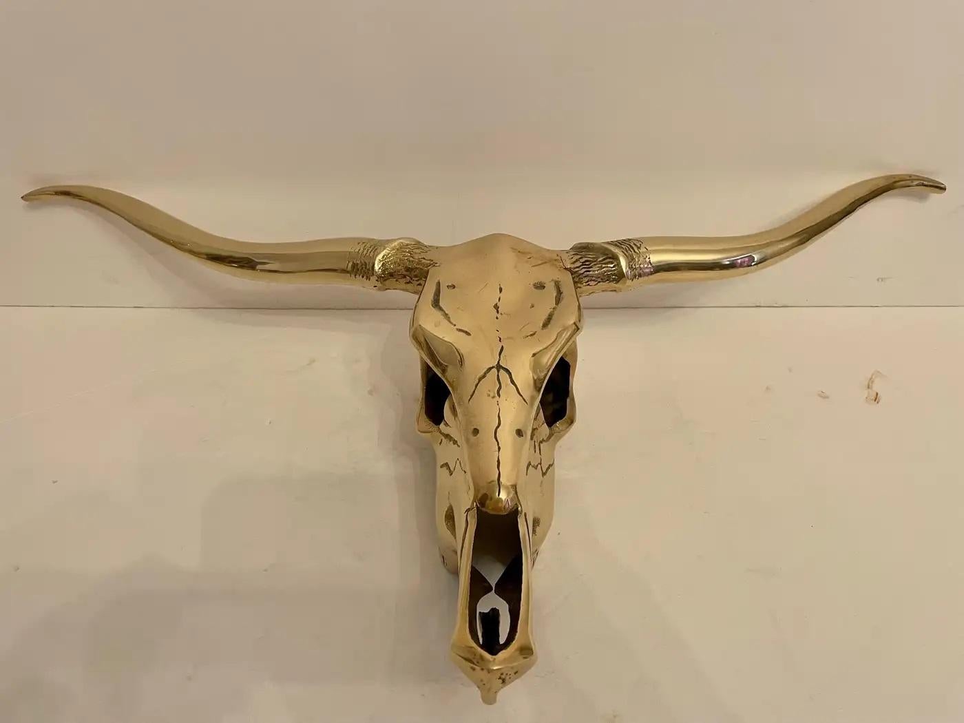 The Hollywood Regency style brass longhorn wall sculpture is a striking and glamorous piece of art that epitomizes the opulence and drama of the Hollywood Regency design era. Crafted from lustrous brass, this wall sculpture features a longhorn