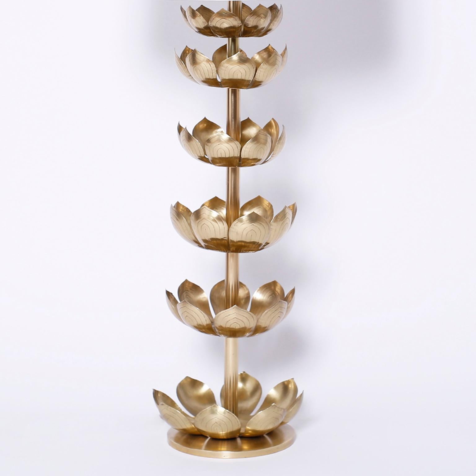 Tall midcentury table lamp composed with brass lotus leaves on a brass stem set in a brass disk base.