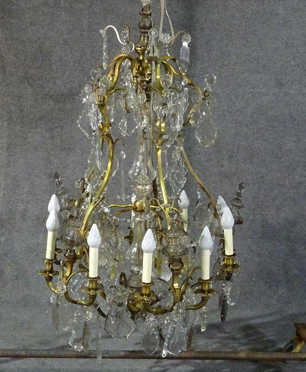 This is a nice chandelier that looks like a 90000.00 Baccarat crystal chandelier at a fair price. The chandelier does have some chips, missing prisms and very minor issues, but is essentially still very pretty and prisms can be replaced of course.