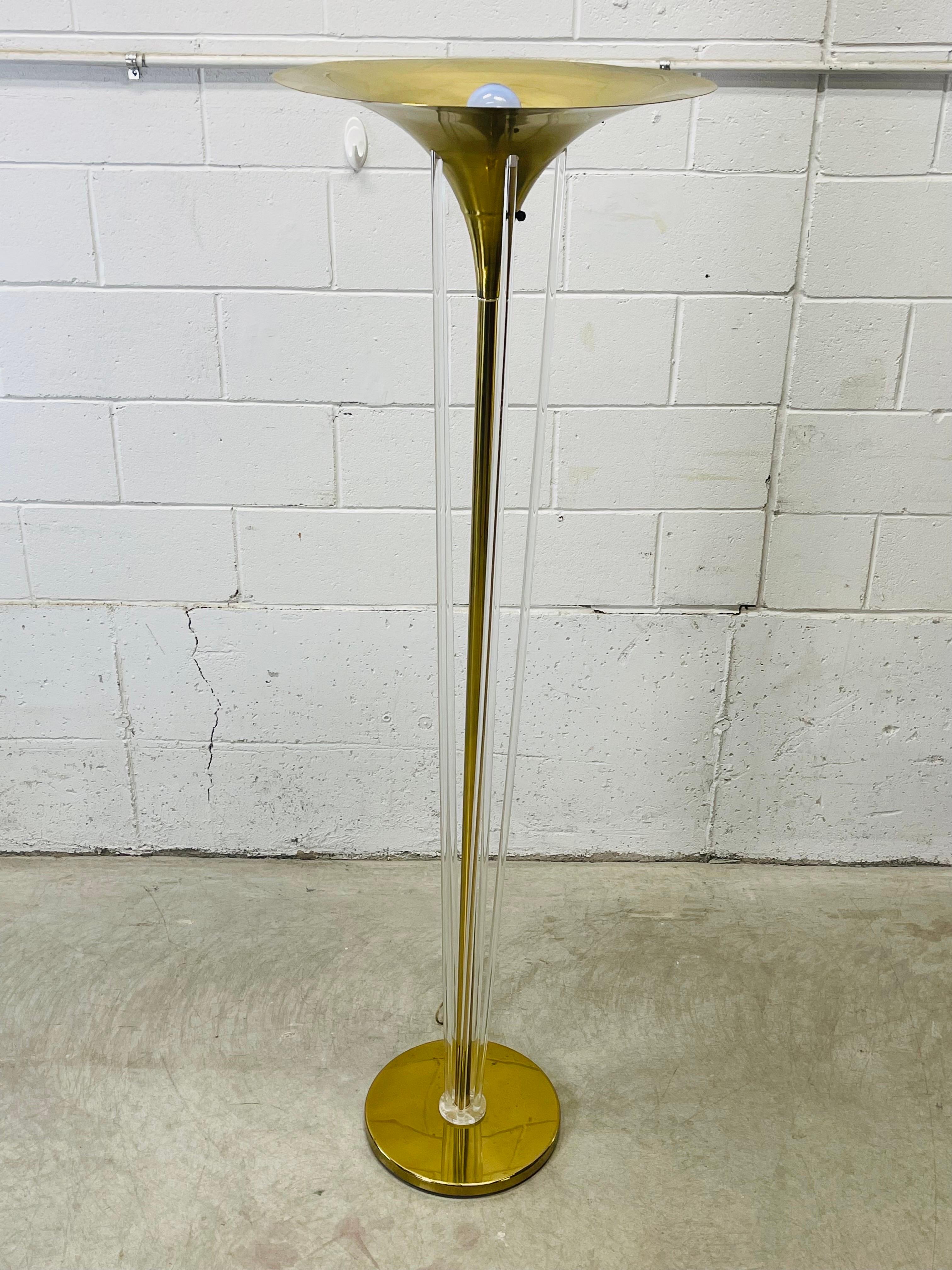 Vintage 1980s brass and lucite torchiere floor lamp. Wired for the US and in working condition. The lamp uses a 3-way standard 100W bulb. The trumpet style shade is 20” Diameter and the base is 13”Diameter. No marks.