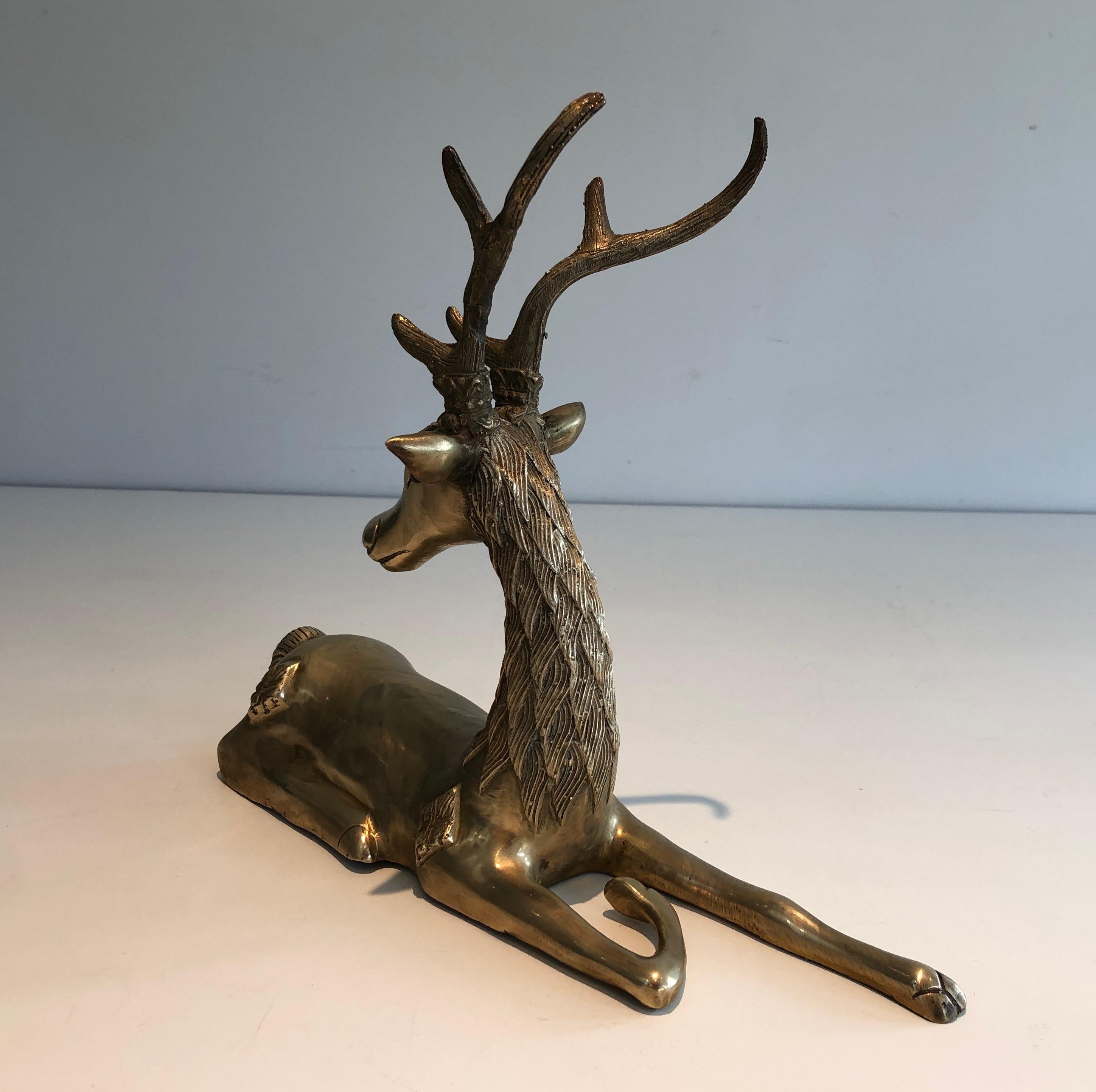 This lying deer sculpture is made of brass with shamanic inlays. This is a French work, circa 1970.