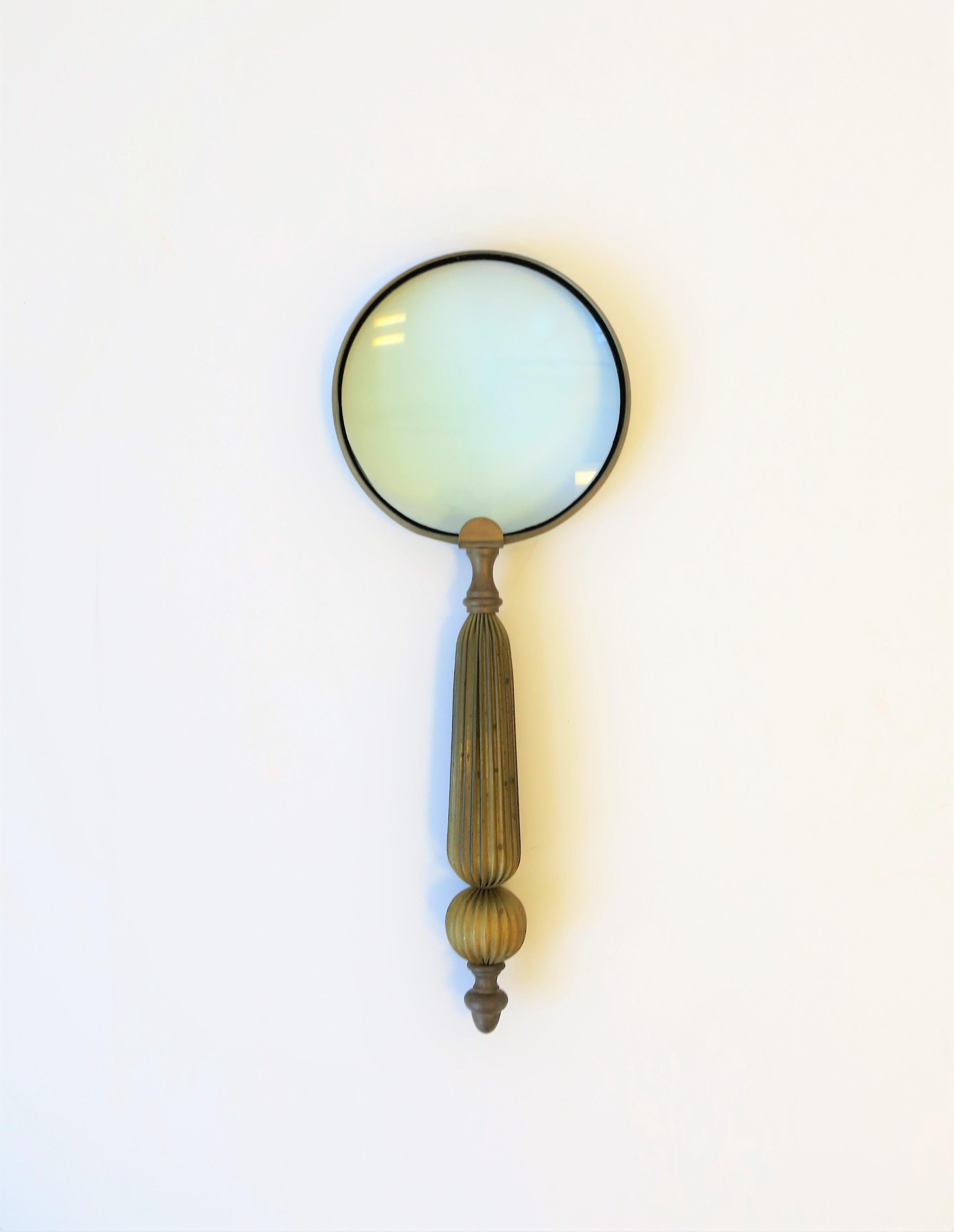 A beautiful vintage, relatively large, brass magnifying glass with fluted handle design. A great desk or library accessory. Piece measures: 15.63