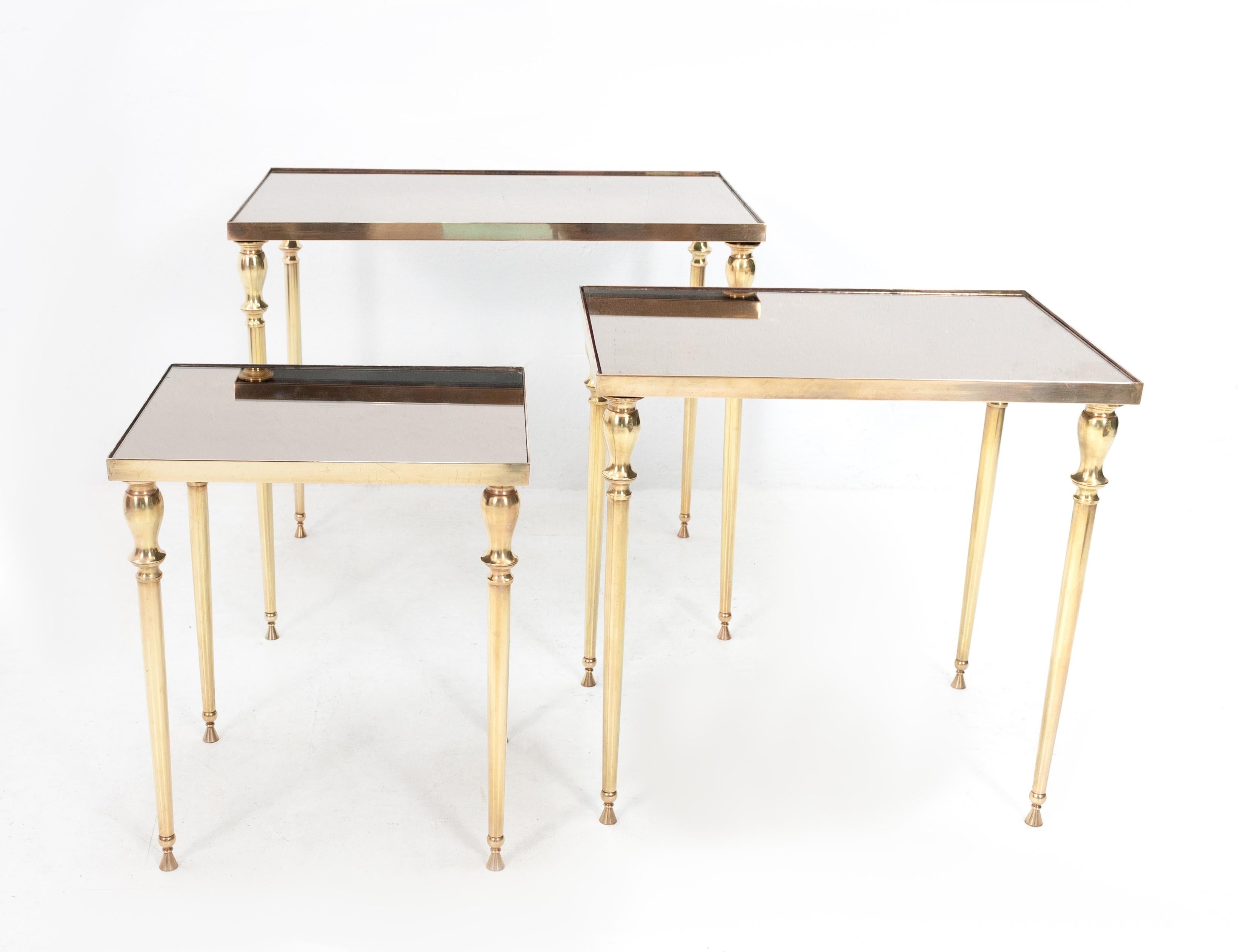 Very nice set off nesting tables. Solid brass. Good quality tables. Comes with there original
distressed bronze mirror tops. Maison Jansen, Paris, 1950s.