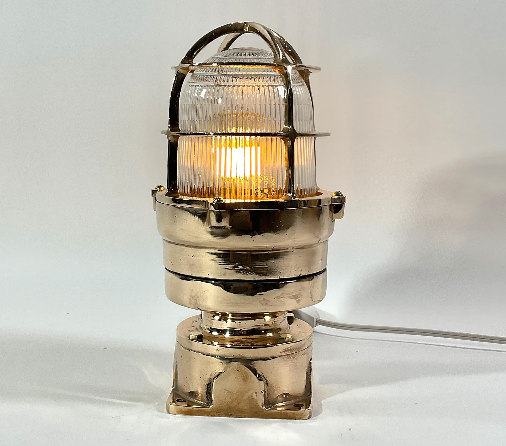 Brass marine beacon by Russel Stoll. Heavy brass ships explosion proof marine beacon. The Fresnel glass lens is protected by a heavy brass cage that is fastened to a sturdy columnar base with four flange. Circa 1960.