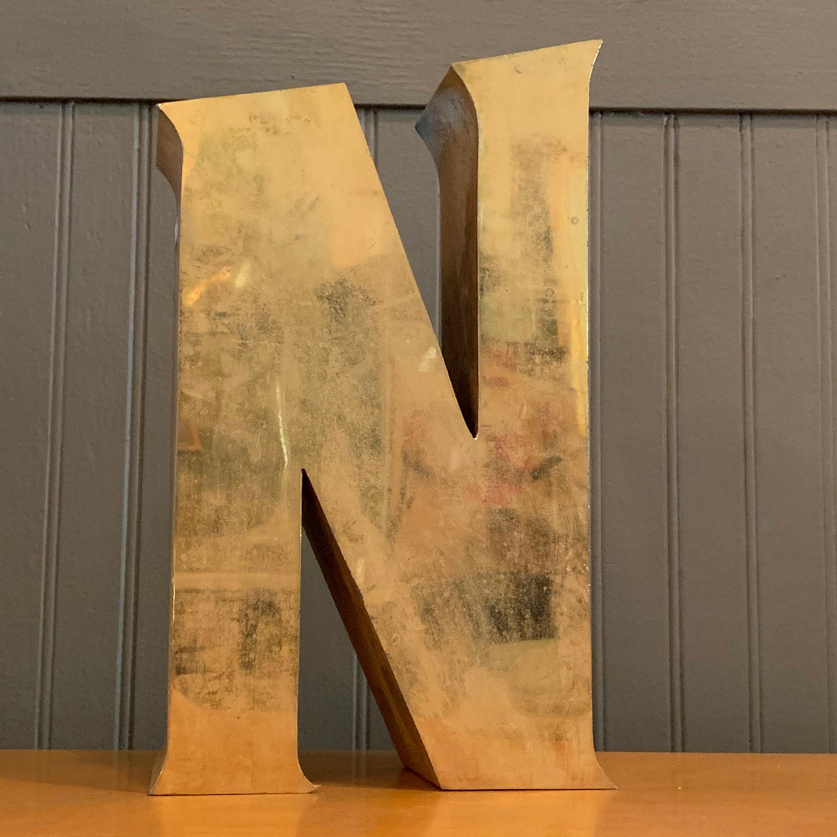Brass, architectural, marquee letter N can stand tabletop or hang on the wall.