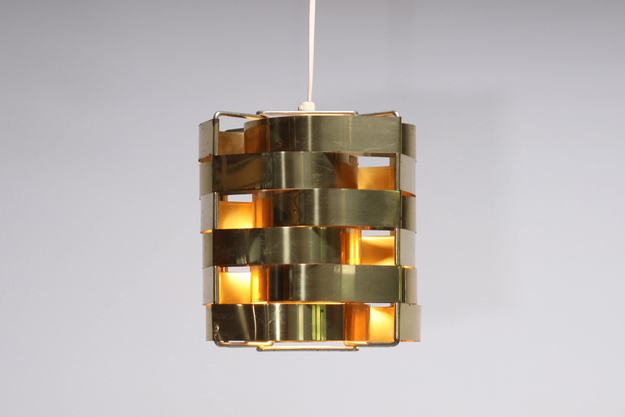 Special and uncommon brass hanging lamp. The brass lamp was made by the French designer Max Sauze for the Max Sauze Studio in the 1970s.
This pendant lamp, called Mars, contains curved brass strips that together create a cube shape.
We were told