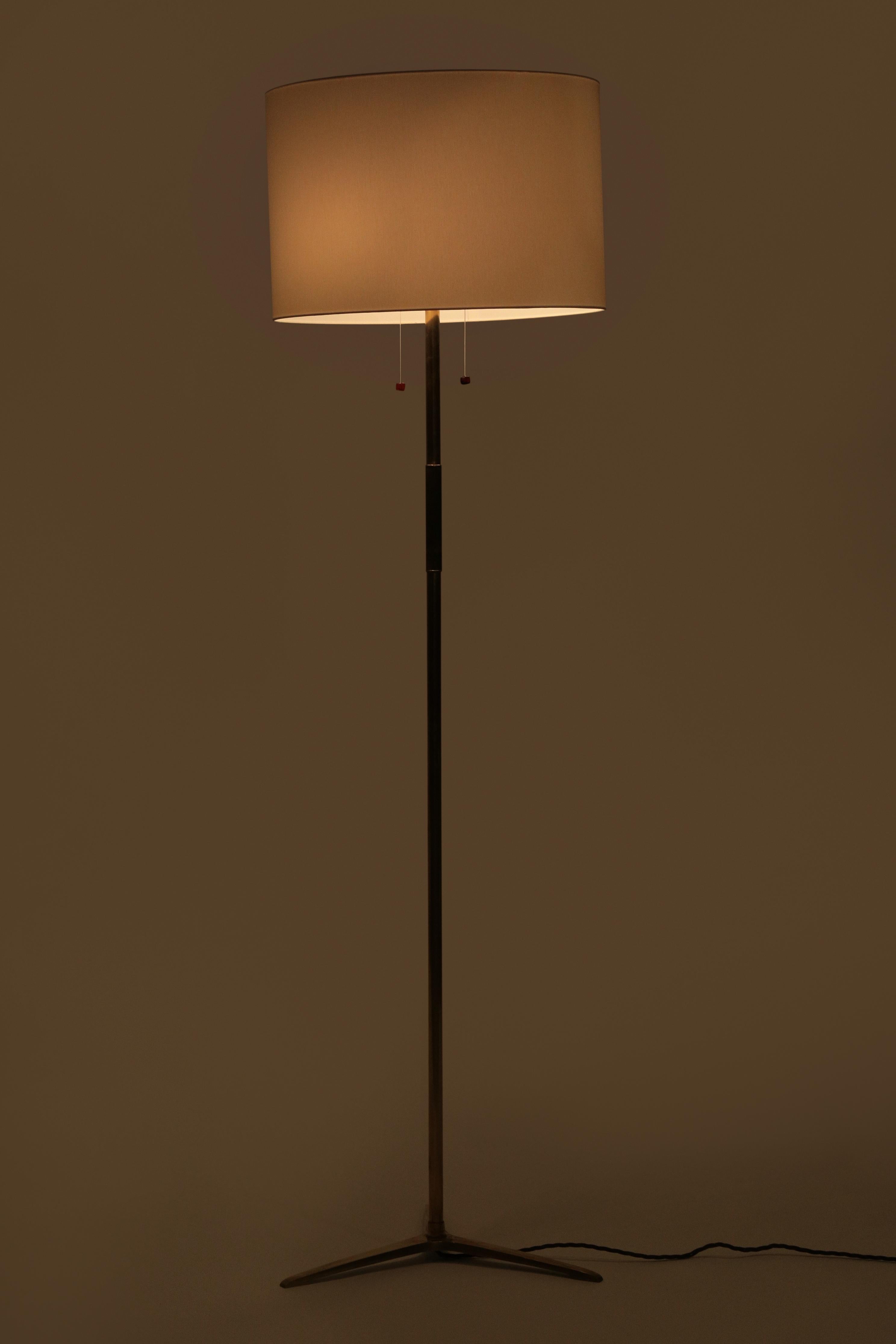 Classy Mégal floor lamp from the 1950s, with a brass frame and a leather and amber pull switch. The lampshade has been refurbished, the lamp rewired and newly polished. In great condition, very elegant, high-quality object.