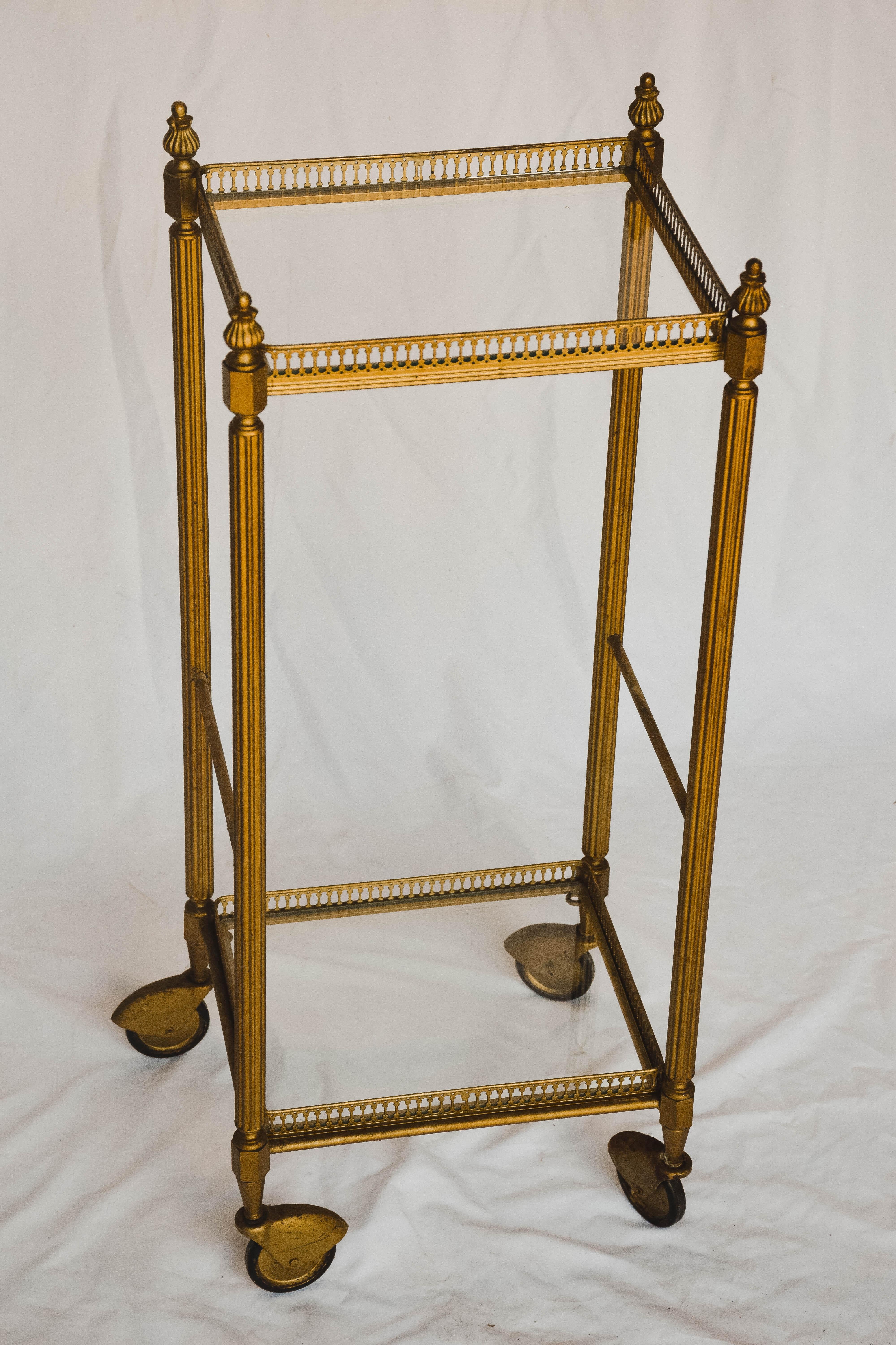 This Mid-Century Modern bar cart is sure to delight. Constructed of brass and glass bringing beauty to the midcentury design. The two glass tiers provides ample space for all your bar needs. It's unusual size would work well as a side table in a