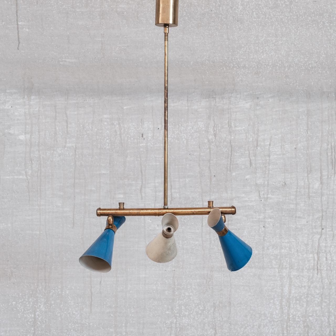 A brass adjustables three way pendant light.

Italy, c1960s.

Original blue and white painted shades, these could be repsrayed upon request.

Good vintage condition, some patination to the brass, some wear to the paint.

Location: Belgium