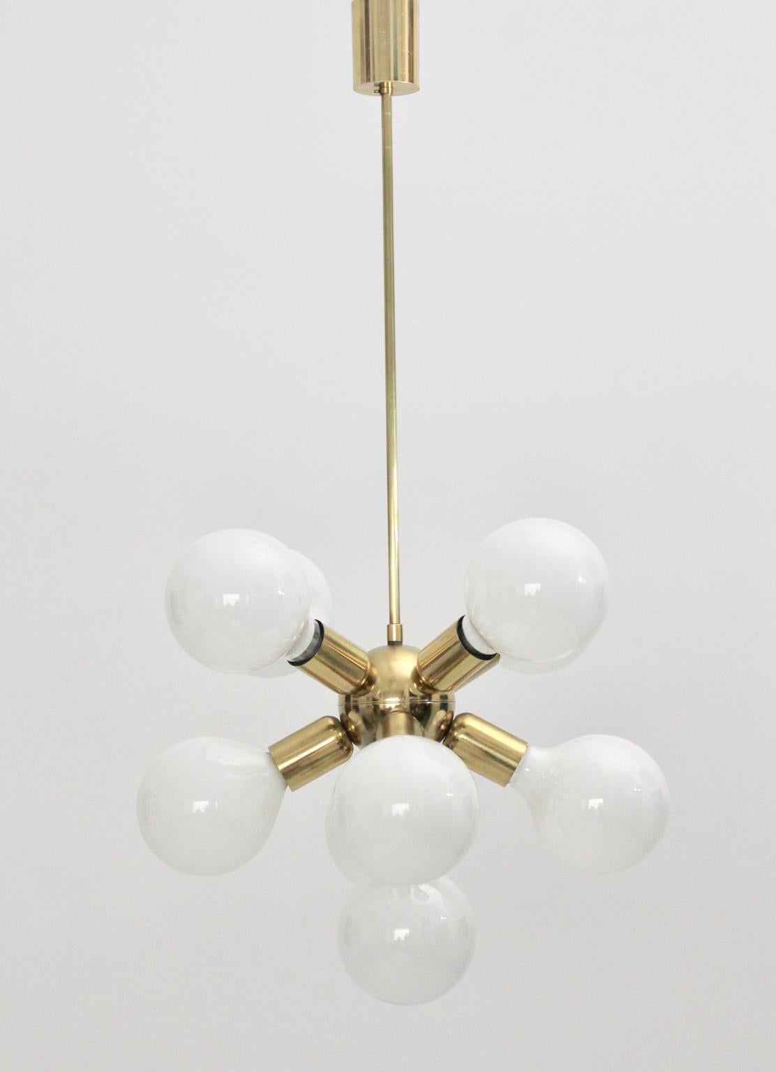 Great Sputnik chandelier made of brass and plastic from the 1970s with nine E 27 sockets.
Very good condition with minor signs of age and use.
Measures: Diameter 45 cm, total height 80 cm.
 