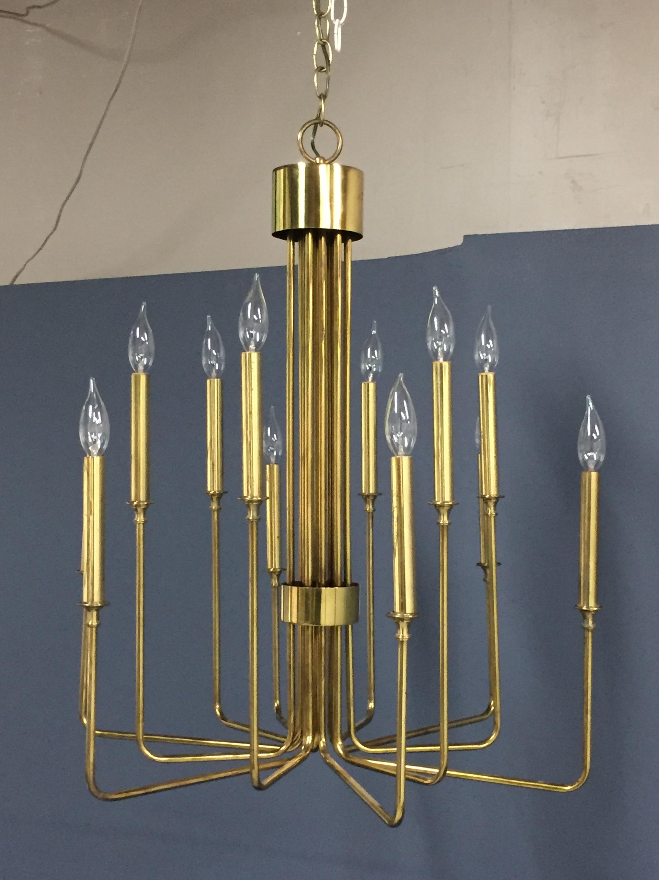 Stunning brass chandelier with twelve arms of two different lengths of alternating brass tube. This chandelier makes a serious statement in any room.

  