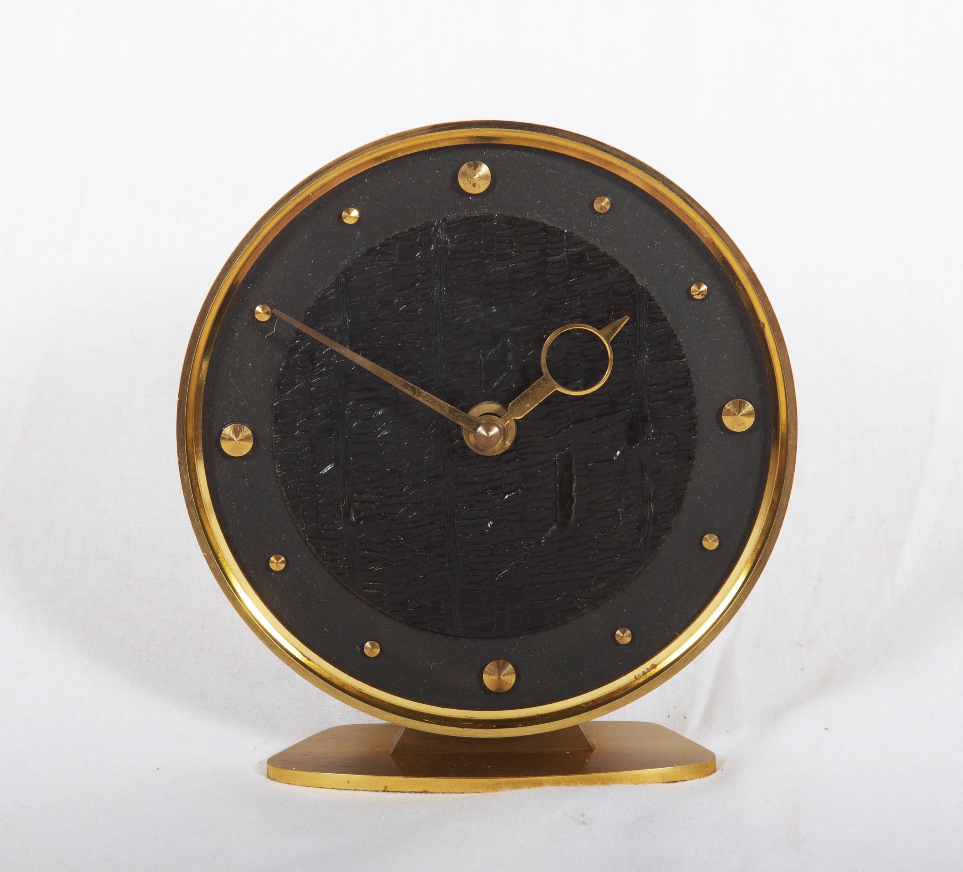 Brass construction with a black clock face, battery movement for one AA-battery from the 1960s.
 