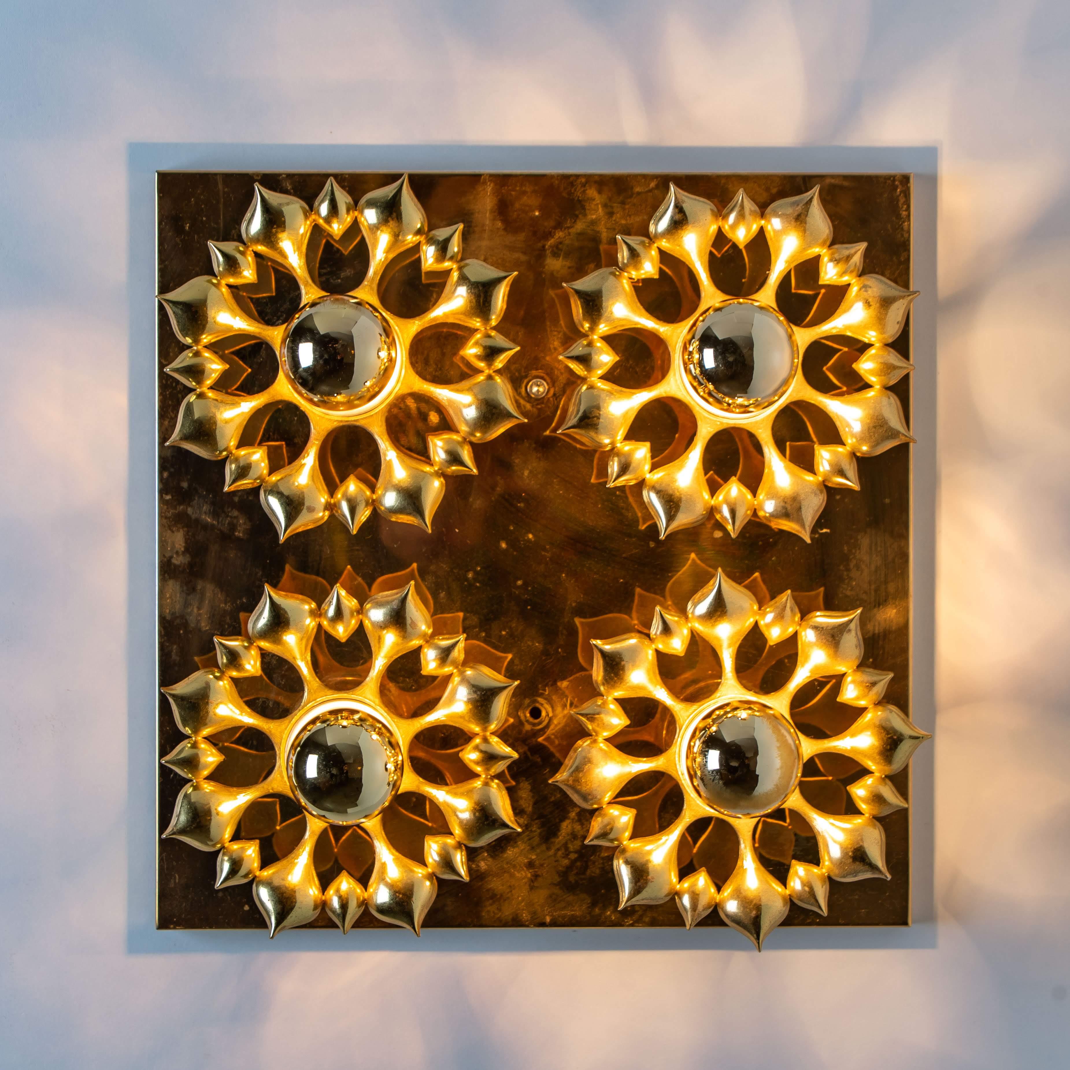 Beautiful flower wall light/flush mount. Manufactured during the 1960s

Heavy quality and in good vintage condition. Cleaned, well-wired and ready to use. The light features 4 E27 sockets. LED suitable.
Different effects can be achieved by