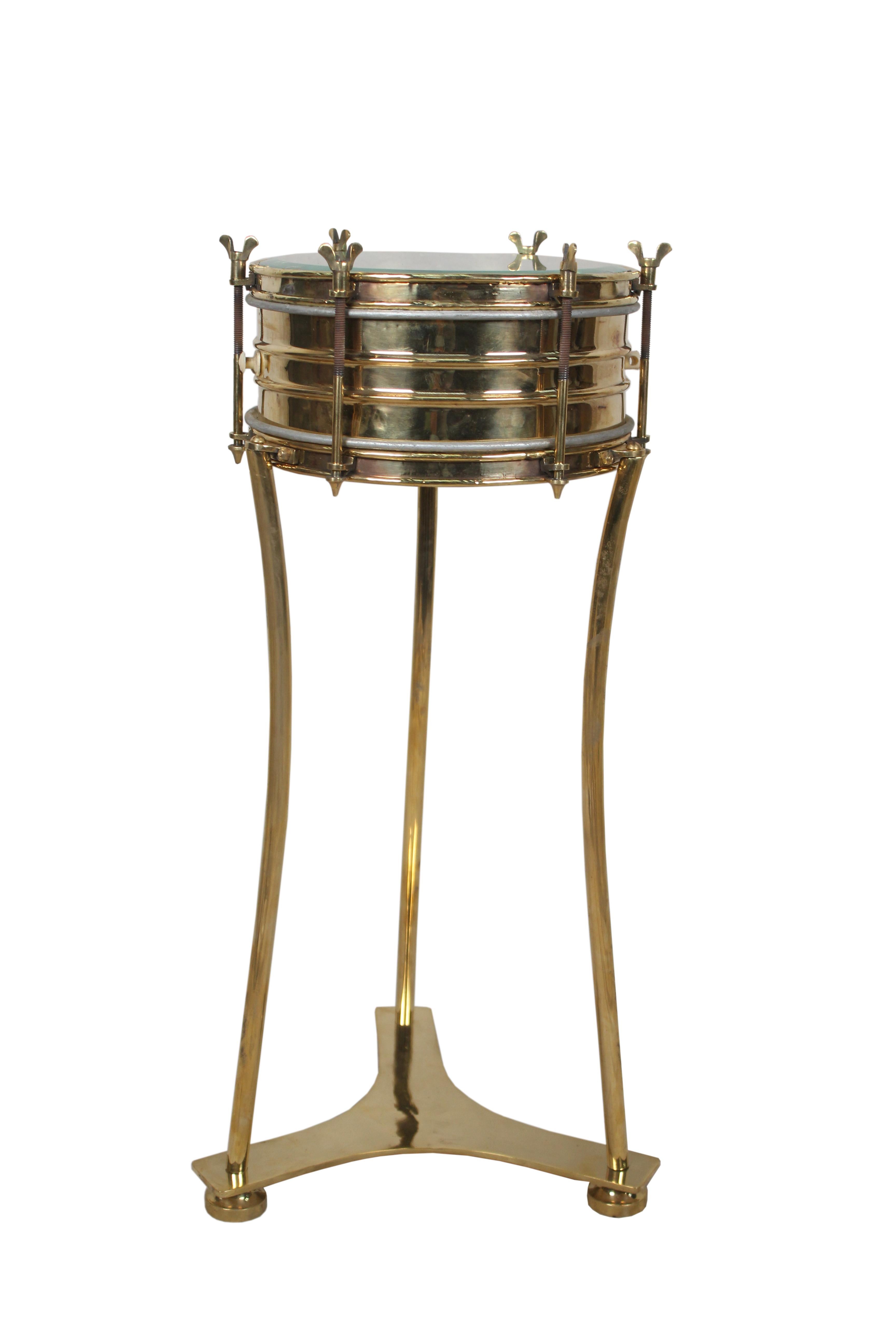 Brass military or marching band snare drum complete with drum heads in working order (possibly replaced in the last few years), bordered with the brass tension keys. I had this made into a side or end table by adding brass legs and base that can be