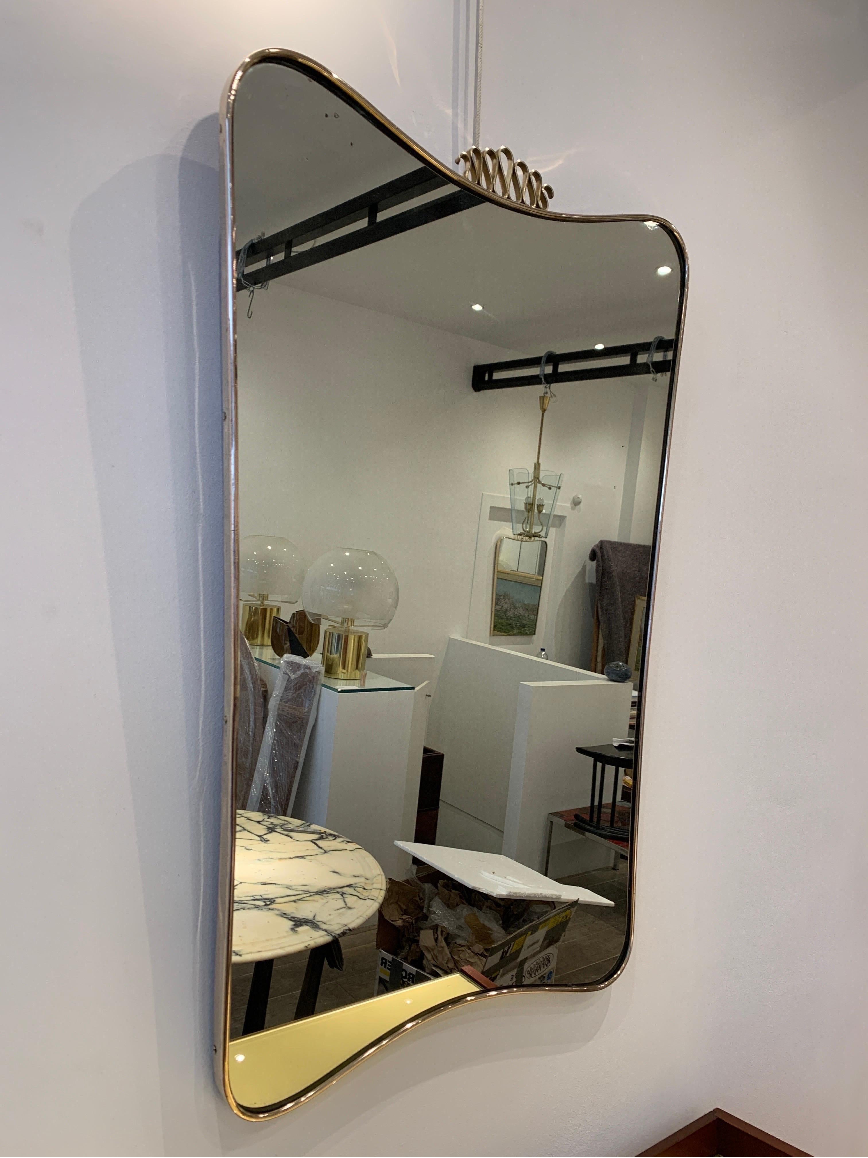 This type of brass mirrors were popular in the 1940s. Gio Ponti designed some of the models. This particular is of the period and attributed to Gio Ponti. Ponti Mirrors were popular in high end Milanese home interior. He was the most famous designer