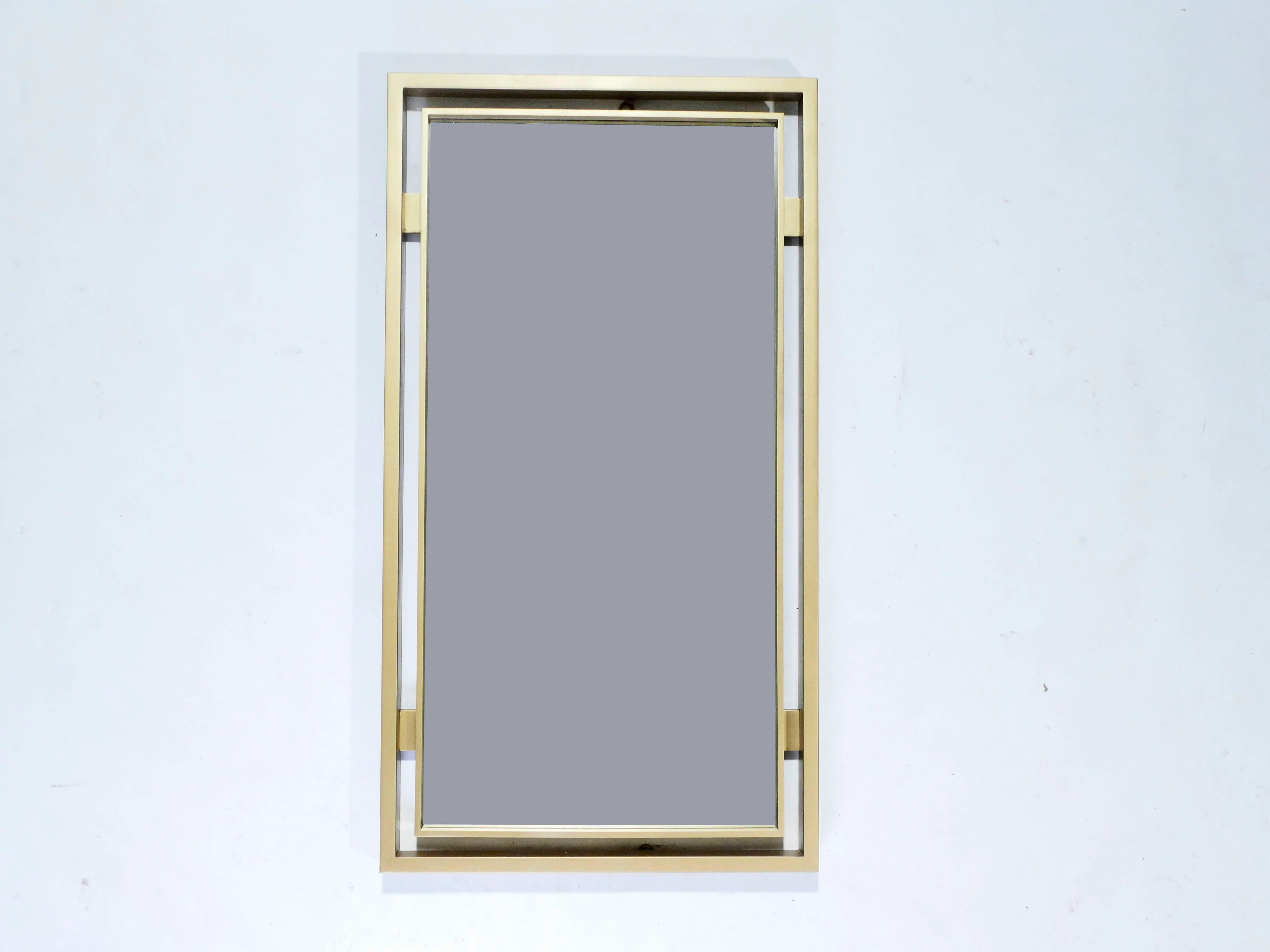 With its strong geometric design, this statement mirror is typical of French designer Guy Lefevre’s work for Maison Jansen. Its imposing mat brass border surrounds the mirror, creating a chic, timeless piece. Found in very good vintage condition and