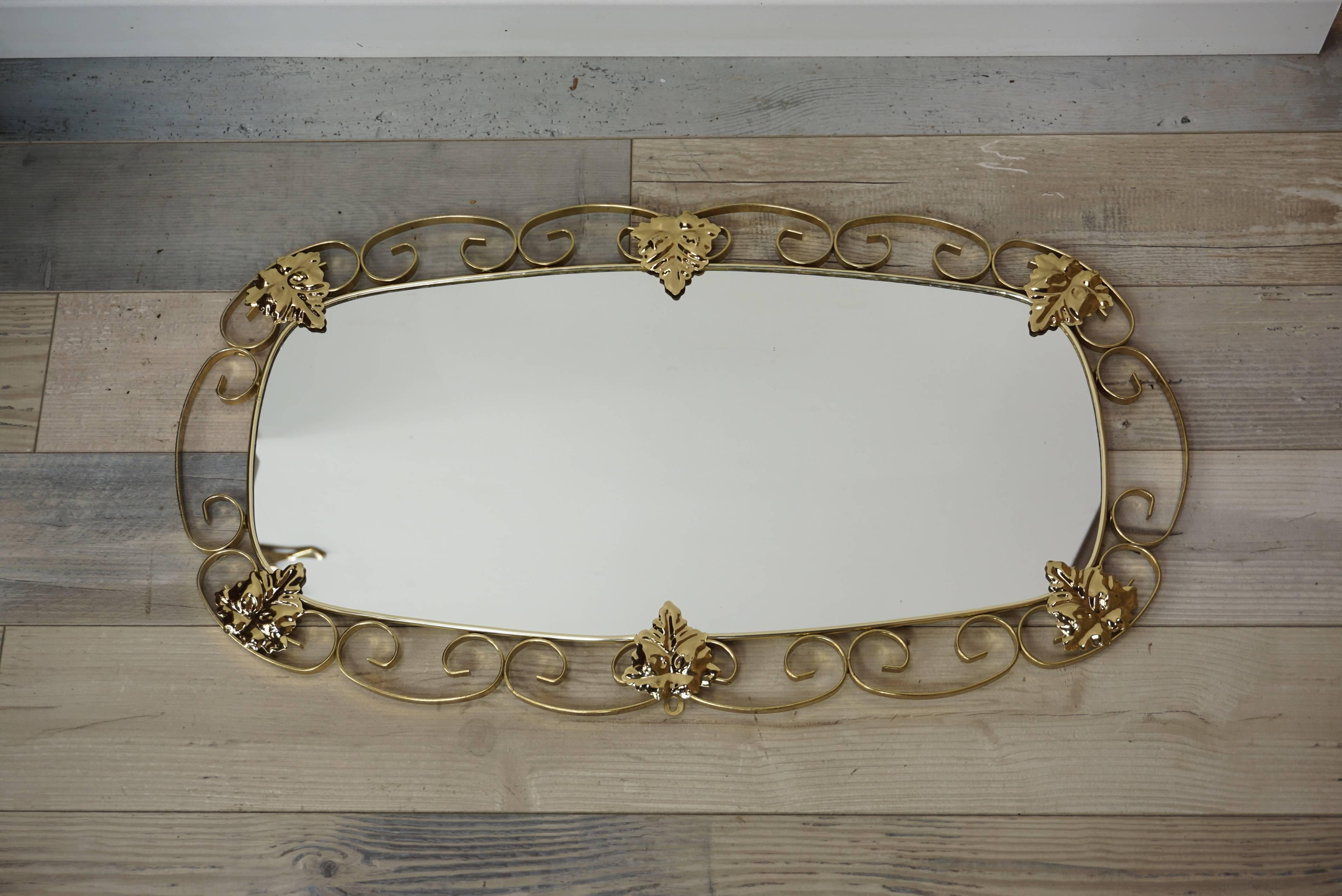 Brilliant and sparkling 1950s-1960s mirror; brass structure with delicate and fine work of scrolls and foliage, all in excellent condition.