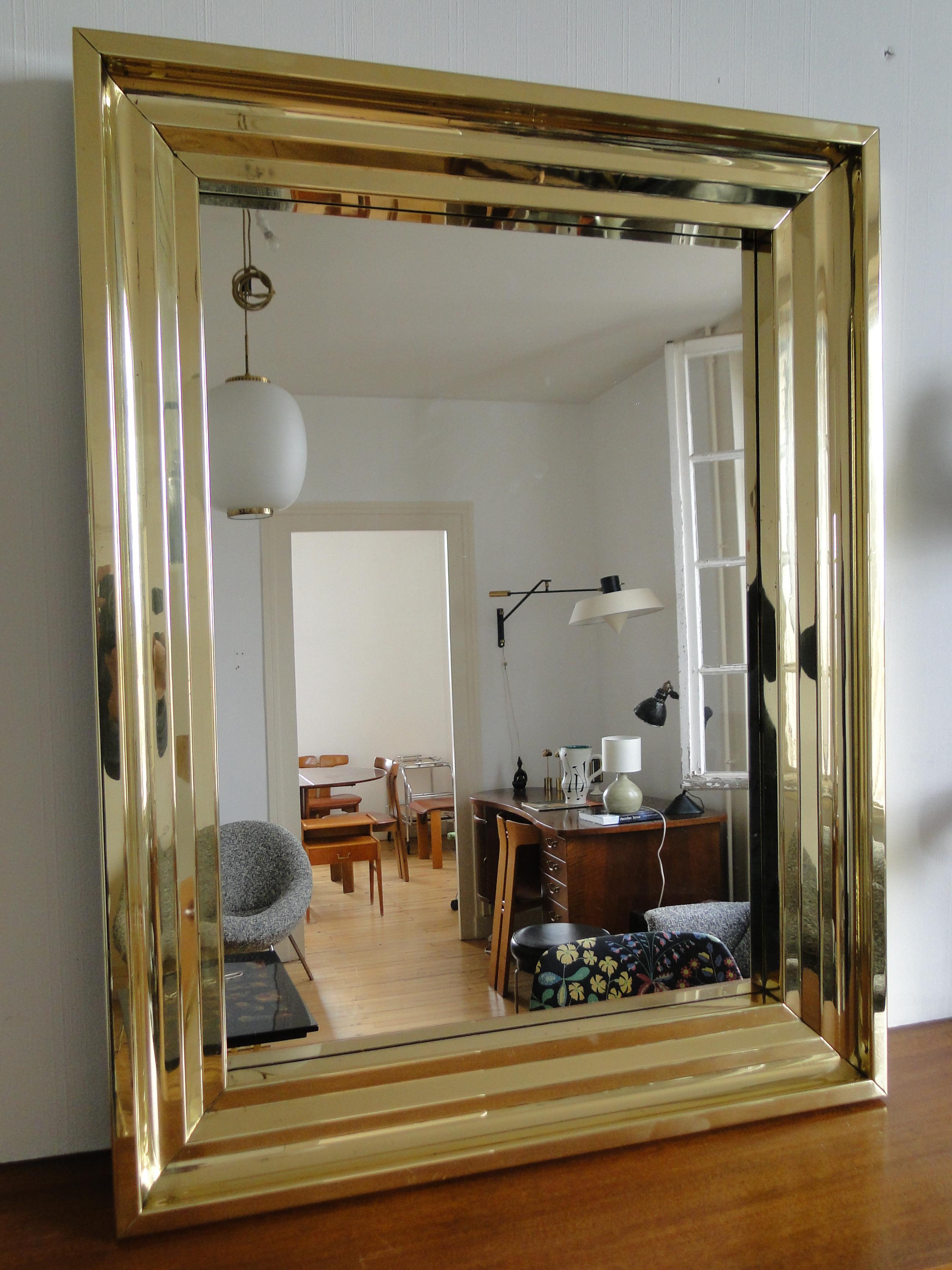 Old polished brass fireplace frame from the Bordeaux region (south west of France), mounted as a mirror from the 1940.

Made in France.

The mirror can be positioned vertically or horizontally. 
Outer bezel in curved polished brass

New mirror

Very
