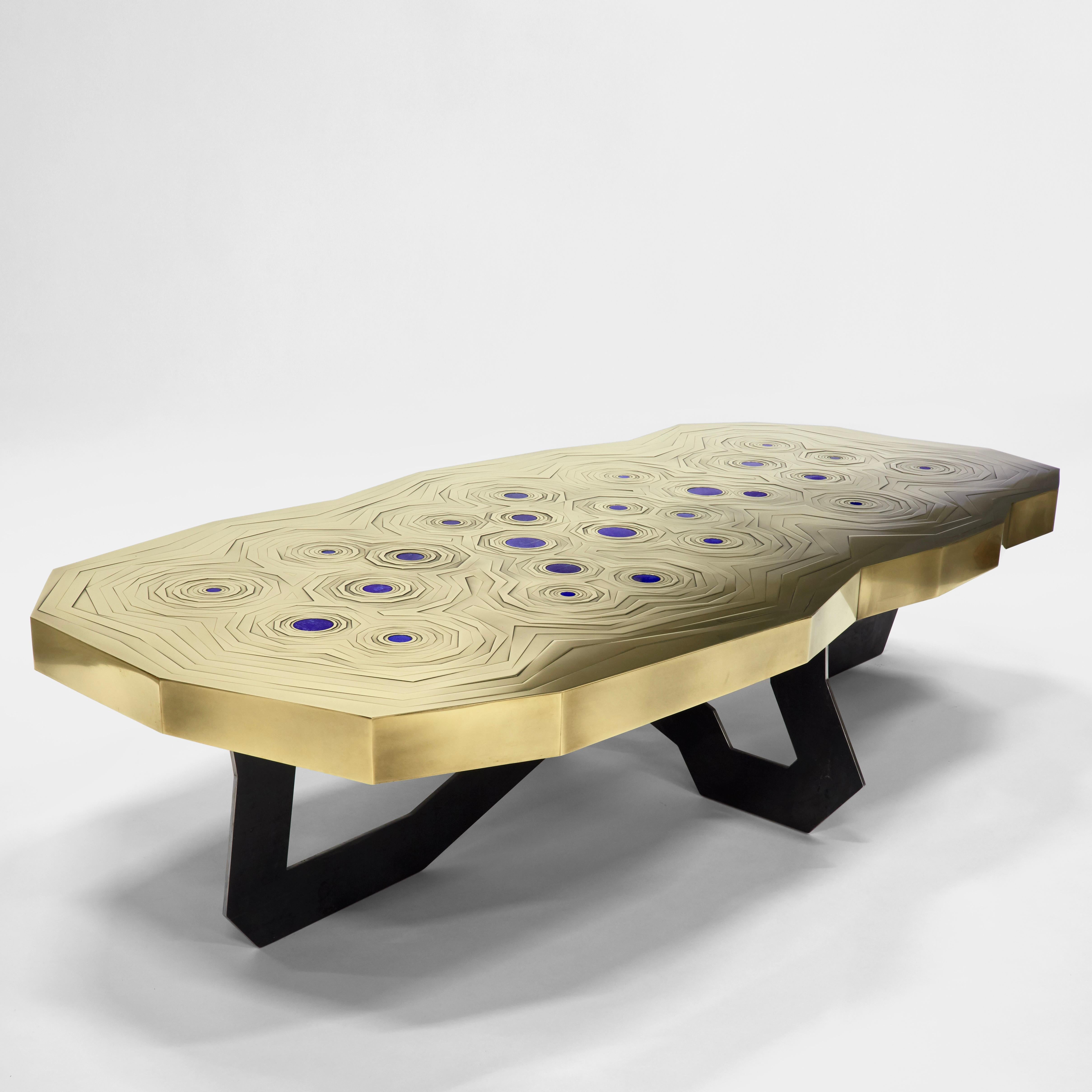 This brass mosaic top with 26 mounted lapis lazuli stones & black steel basement coffee table by Erwan Boulloud is a true masterpiece giving light and energy to an entire environment.
Signed piece on the bottom.

Graduated from the Ecole Boulle