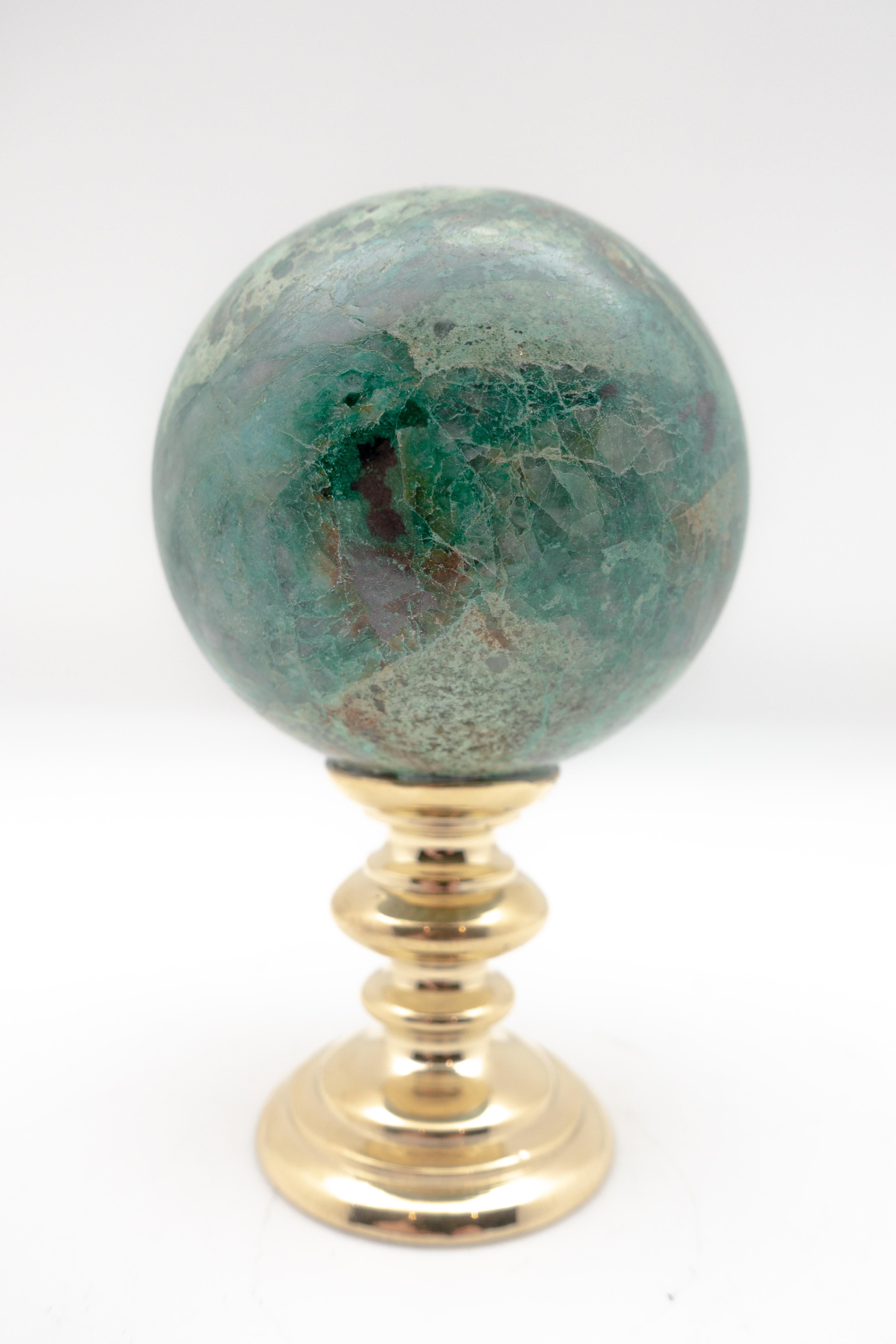 Chrysocolla sphere mounted on a brass stand. The beautiful blue-green of chrysocolla has made it a prized gemstone in ornamental use since antiquity. Measures: 2.75
