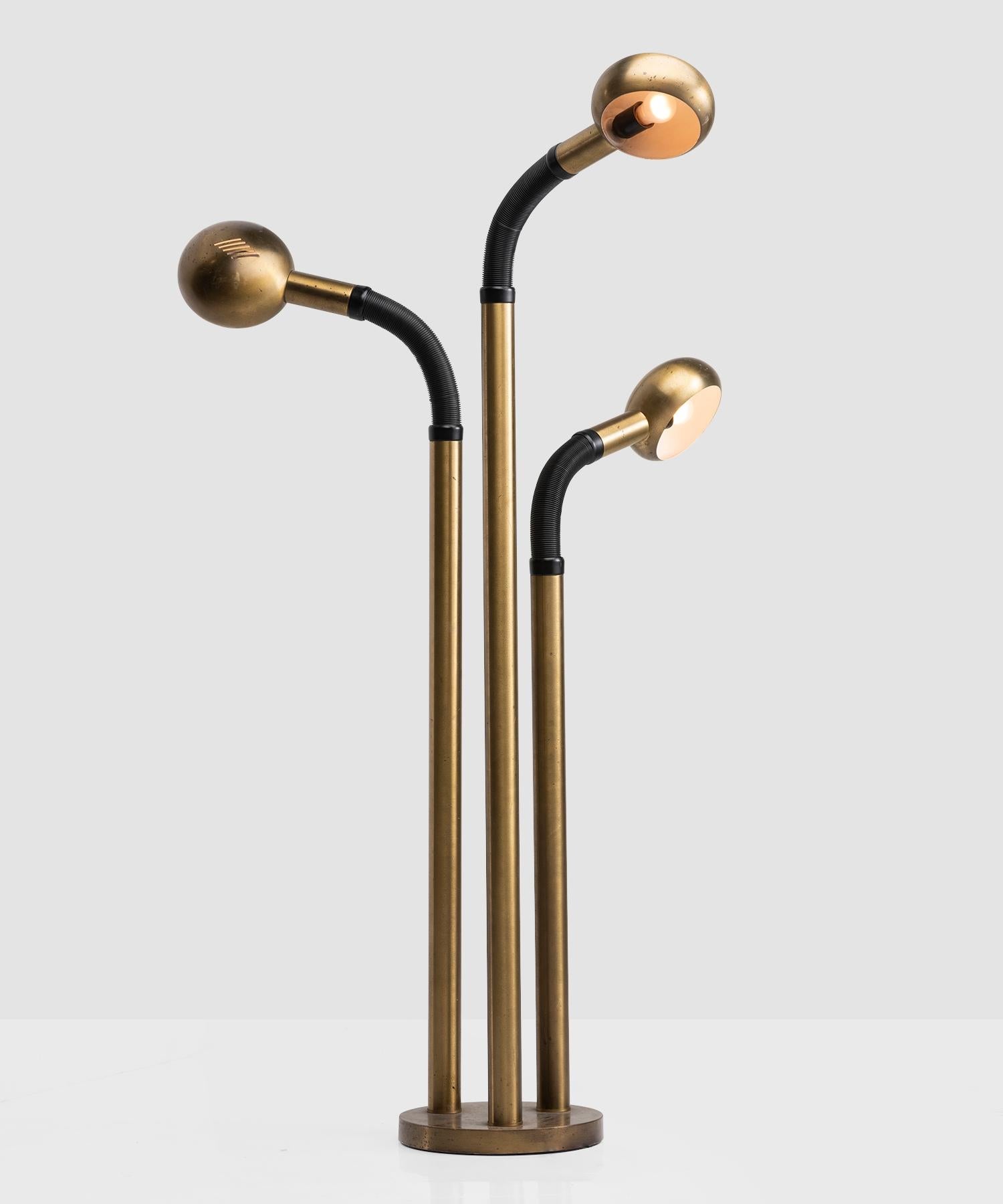 Unique brass floor lamp with (3) perforated heads on adjustable black arm.