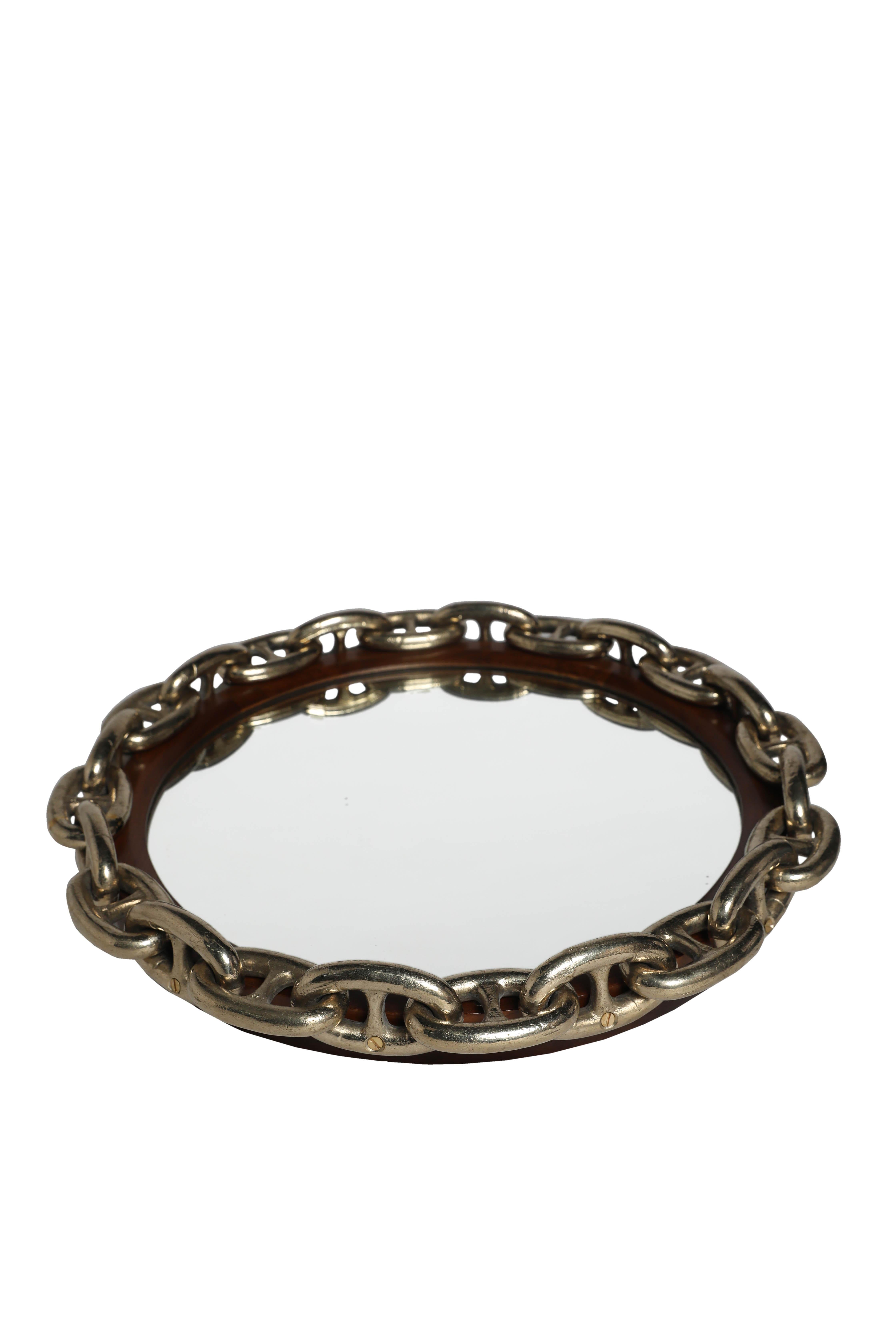 Rare, large brass chain links from the 1960's have been attached to a round, teak wood mirror frame.  Designed by Deborah Lockhart Phillips.  

The Lockhart Collection is a personally curated gallery of antiques and fine jewelry, owned and operated