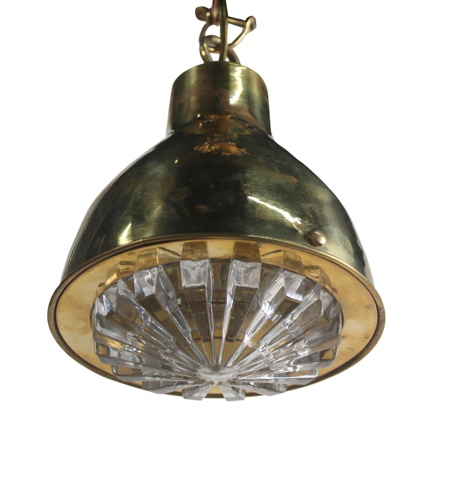 A brass ship's pendant light with a textured glass Fresnel lens shade, 1970s. Takes a standard base light bulb and comes with 4' of brass chain and ceiling canopy. Rewired for American use.

 