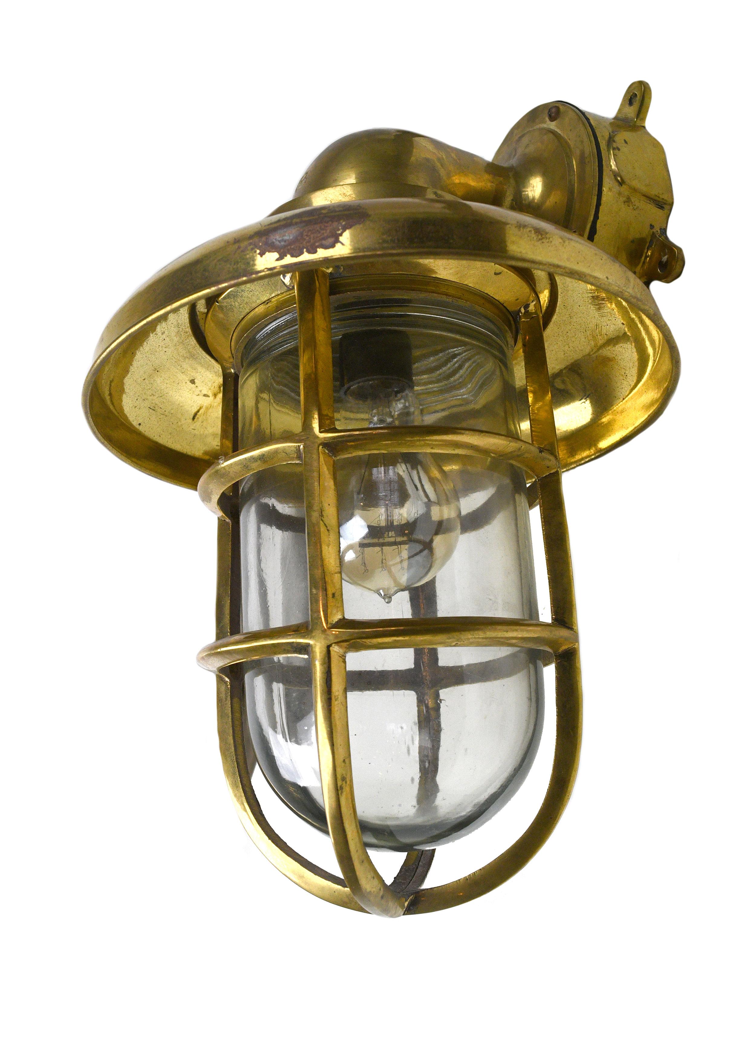 This wonderfully reflective brass and glass sconce features a look that is both Industrial and nautical. This sconce would bring an adventurous seafaring vibe to any space!