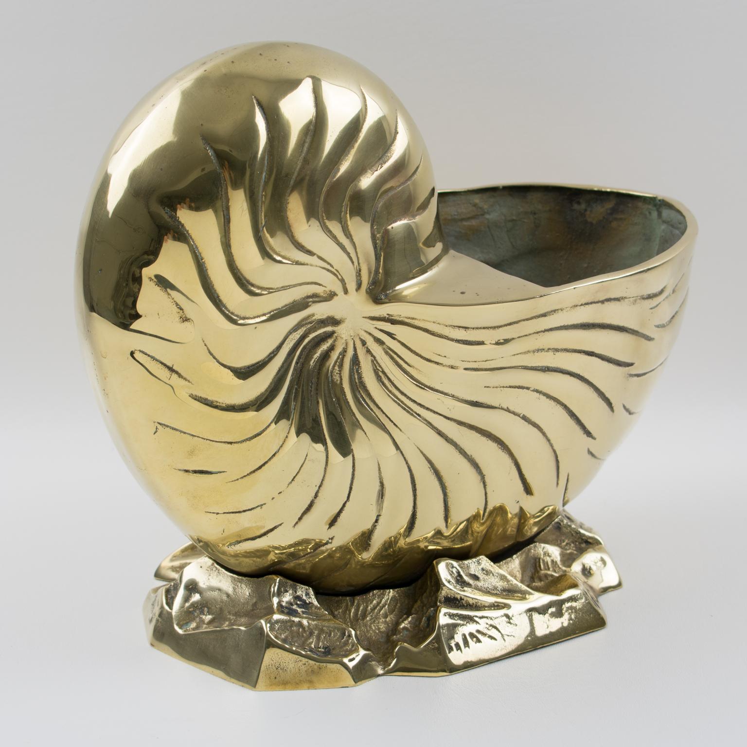 This stylish modernist polished brass animal sculpture is an ultra-chic decorative piece. Use it as a wine cooler or bottler holder, this bar accessory boasts a whimsical sculptural large nautilus shell on a stylized sea-shaped base. This brass