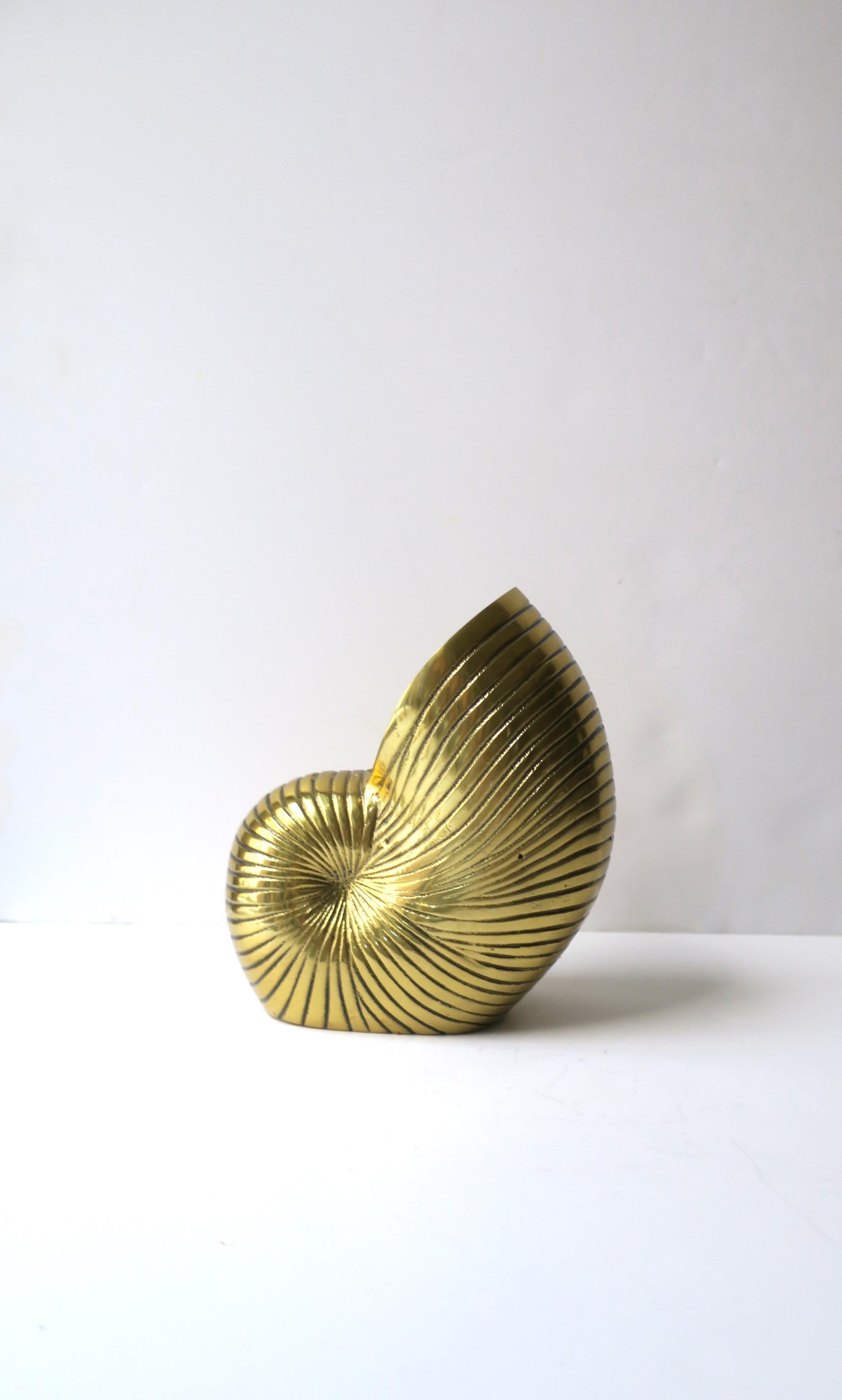 A substantial brass nautilus seashell vase, planter, or decorative object. A great decorative object, planter, or vase for a table, shelf, vanity/bath area, etc. Many uses. Dimensions: 7