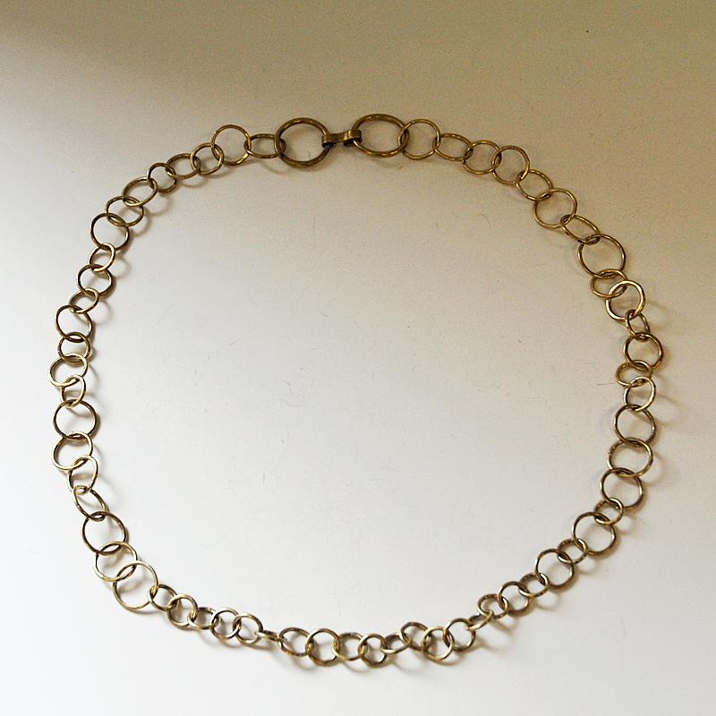 Brass link necklace or to be used as a hip link by Norwegian silversmith Anna Greta Eker. Norway 1960s-1970s. Linked together with brass circles into a long leech. Marked with her stamp AGEker.
Measures: Chain: 88 cm L total length. Diameter of