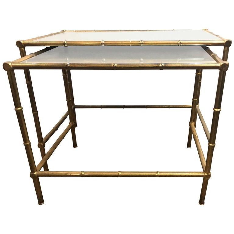 A brass nest of tables with mirror tops in bamboo form.

Measurements for the tables:
Big table H 19, W 24.5, D 4.25
Small table H 17.75, W 20.75, D 13.5.