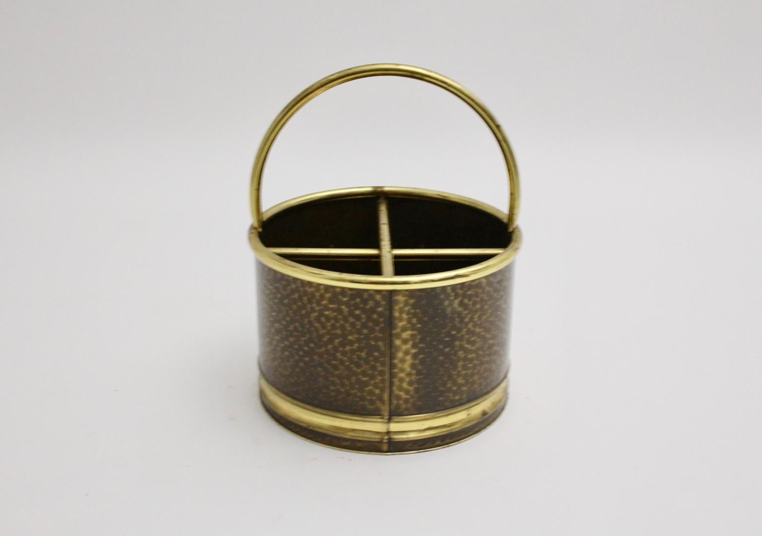 This round shaped magazine rack was made of hammered brass. Inside are four compartments and also at the top it features a handle.
The magazine rack shows a sign 