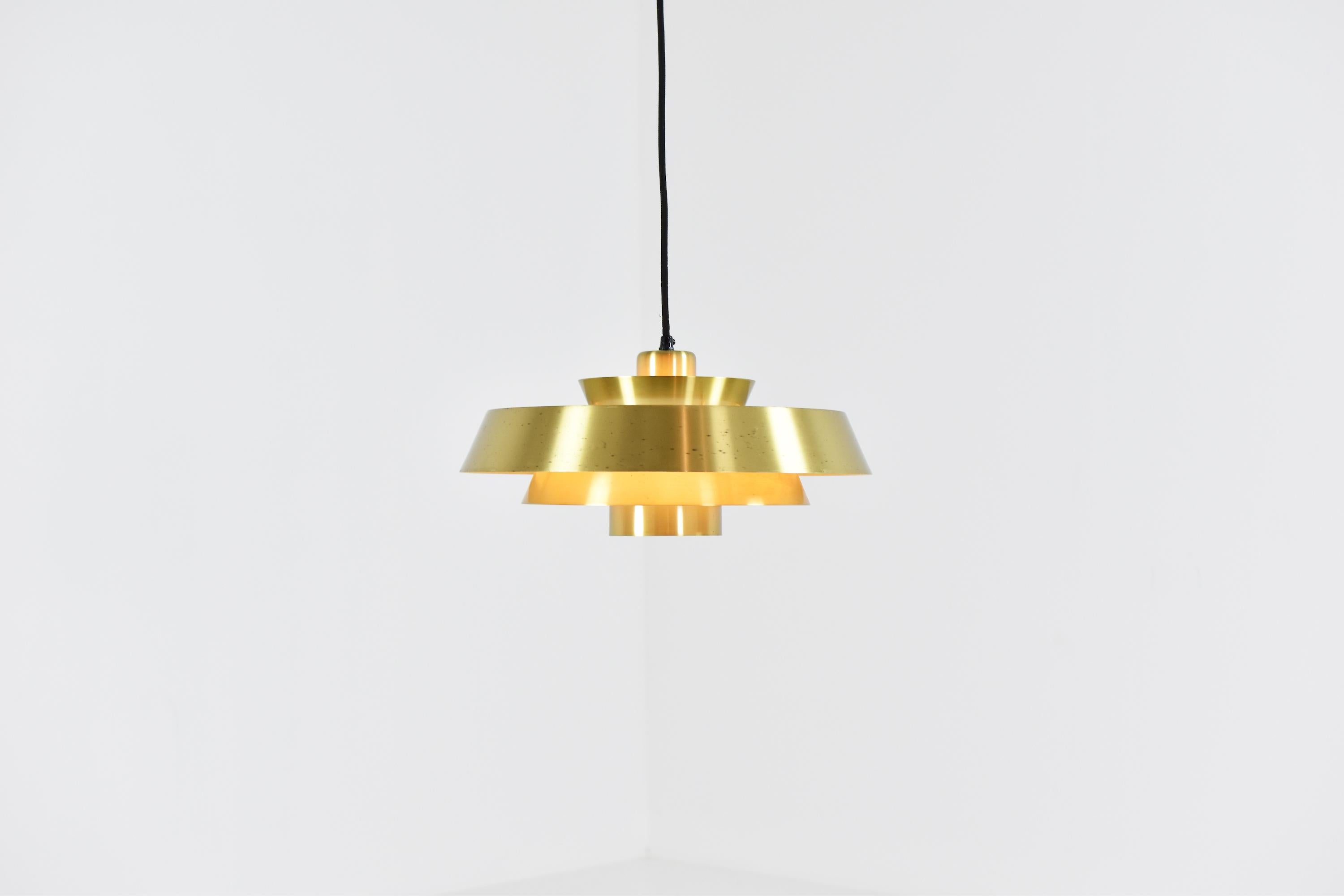 Lovely brass ‘Nova’ pendant designed by Jo Hammerborg for Fog and Mørup, Denmark, 1960s. This midcentury pendant remains in a very good original vintage condition and is newly rewired!