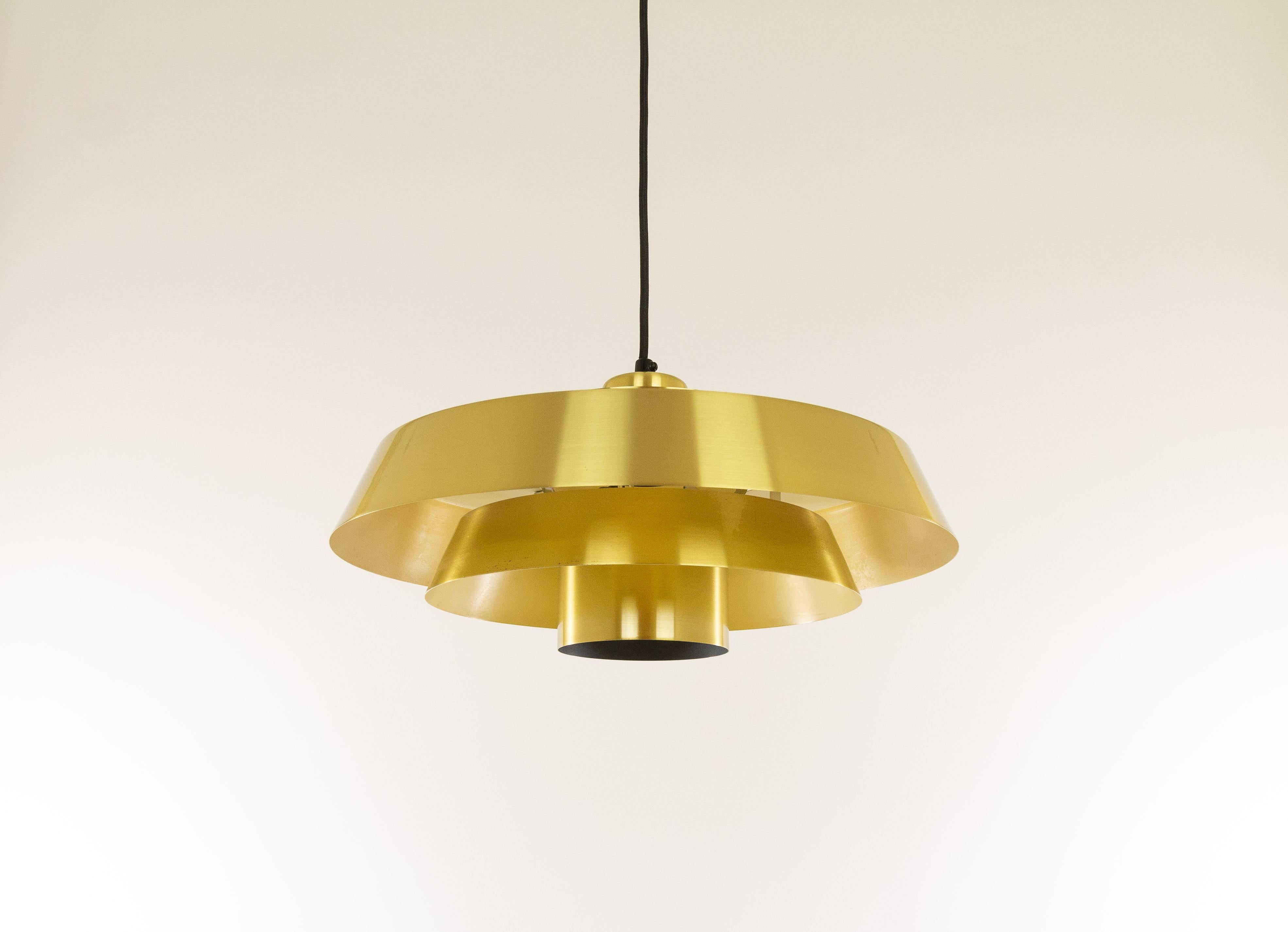 Brass Nova pendant designed in the 1960s by Jo Hammerborg, main designer of Danish lighting manufacturer Fog & Mørup in the 1960s and 1970s.

'Nova' was produced in three different metals: copper, brass and aluminium. This is the brass version; on