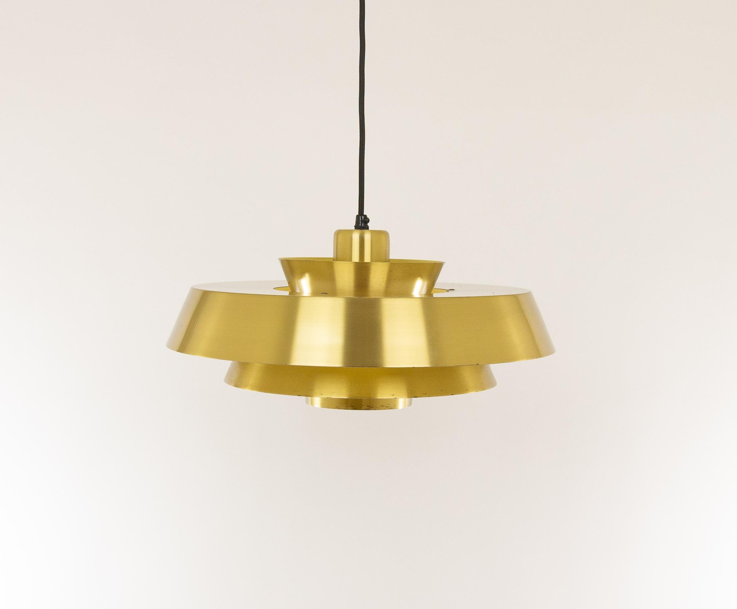 Brass Nova pendant designed in the 1960s by Jo Hammerborg, main designer of Danish lighting manufacturer Fog & Mørup in the 1960s and 1970s.

This model was produced in three different metals: copper, brass and aluminium. This is the brass Nova