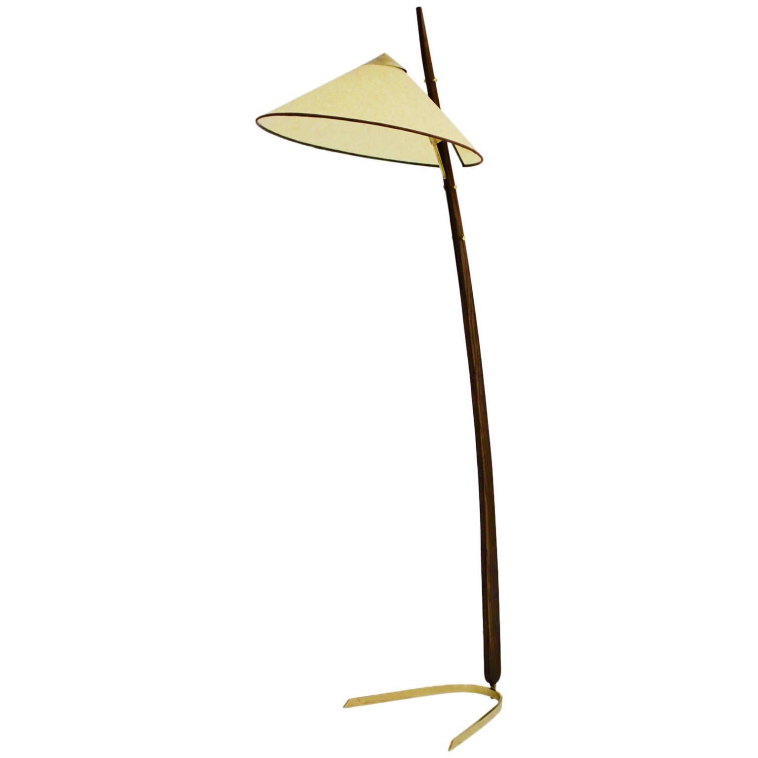 Oak brass Mid-Century Modern floor lamp, which was designed and manufactured by Rupert Nikoll 1950s Austria.
The floor lamp is composed of a solid oak stem with brass details and a parchment paper shade.
Beautiful brass details like fittings and