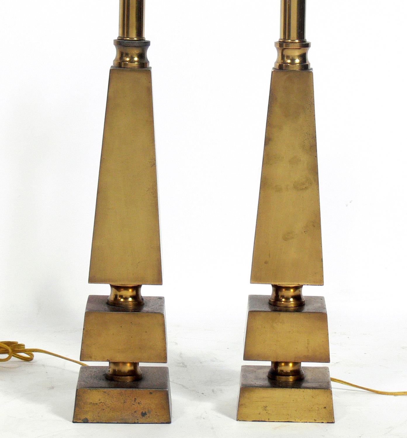 Pair of brass Obelisk lamps, designed by Gilbert Rohde for the Mutual Sunset Lamp Company, circa 1930s. Signed with the manufacturer's stamp underneath. They have been rewired and are ready to use. They retain their warm original patina with age